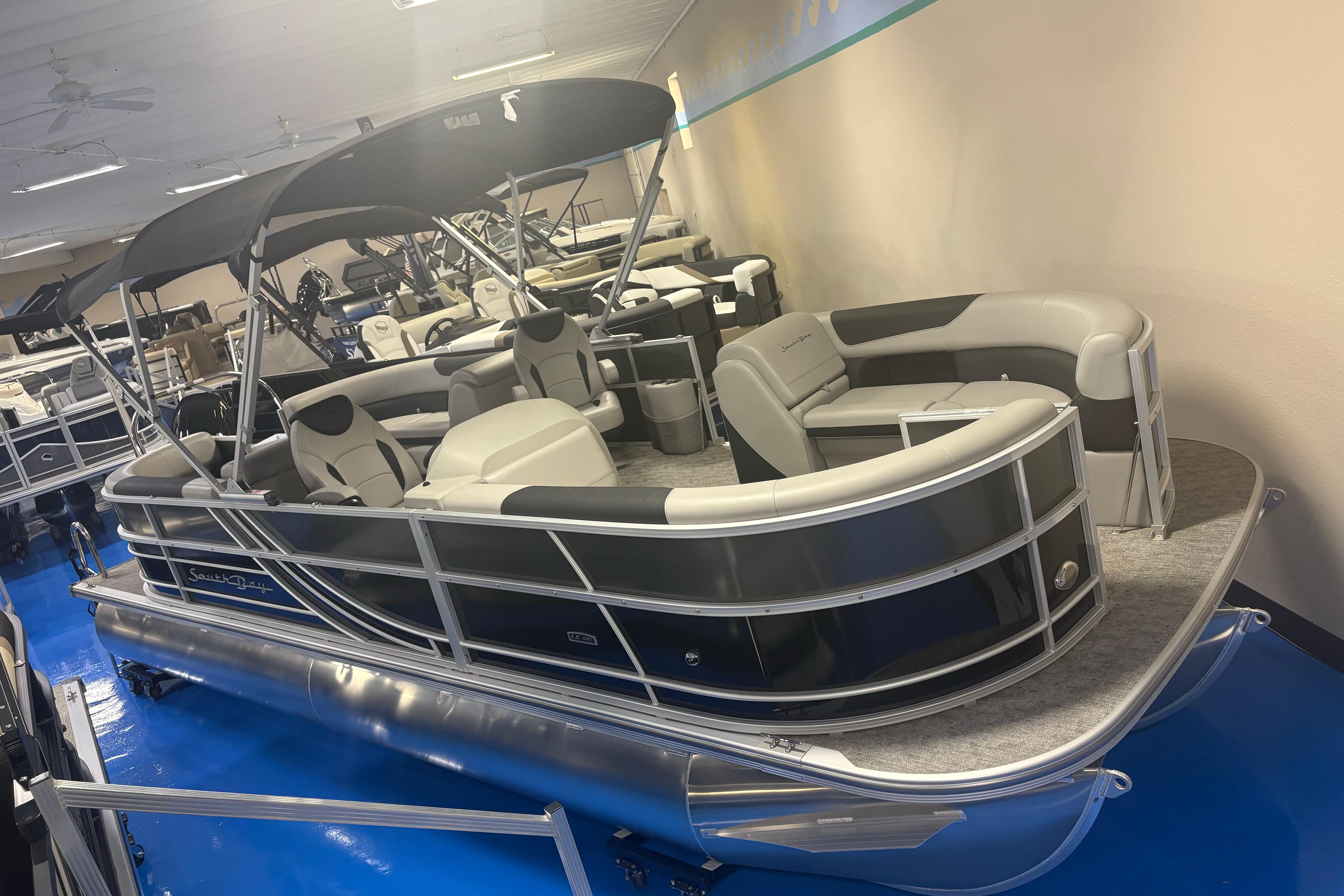 2025 South Bay 224RS LE 2.75 pontoon boat displayed indoors with seating and canopy.