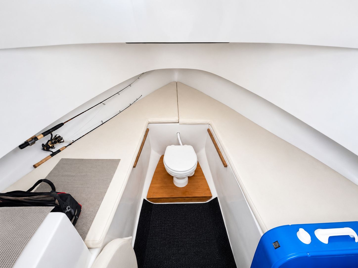 Interior of a 1992 L&H 33 with a toilet and fishing rods.