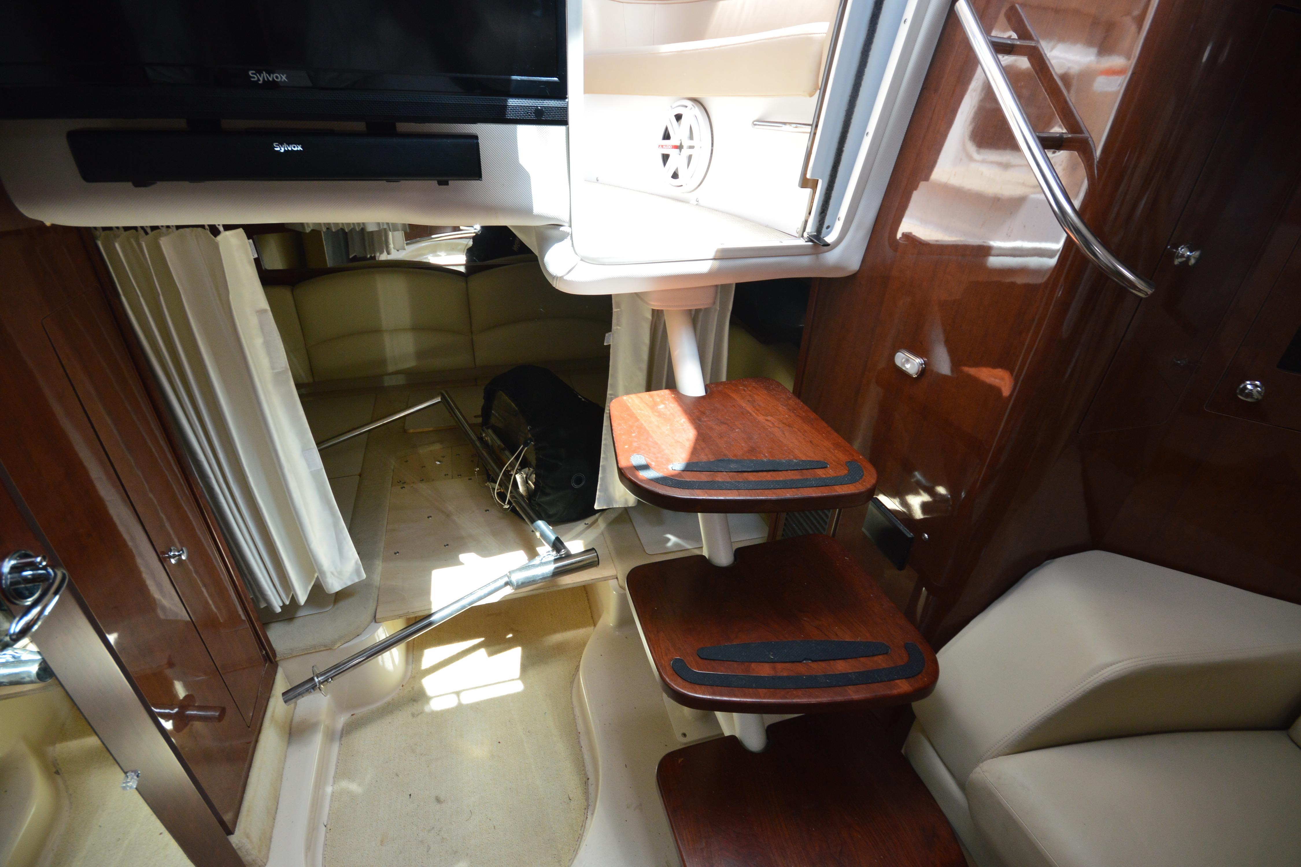 Interior of 2013 Four Winns V375 yacht with wooden steps and luxurious seating.
