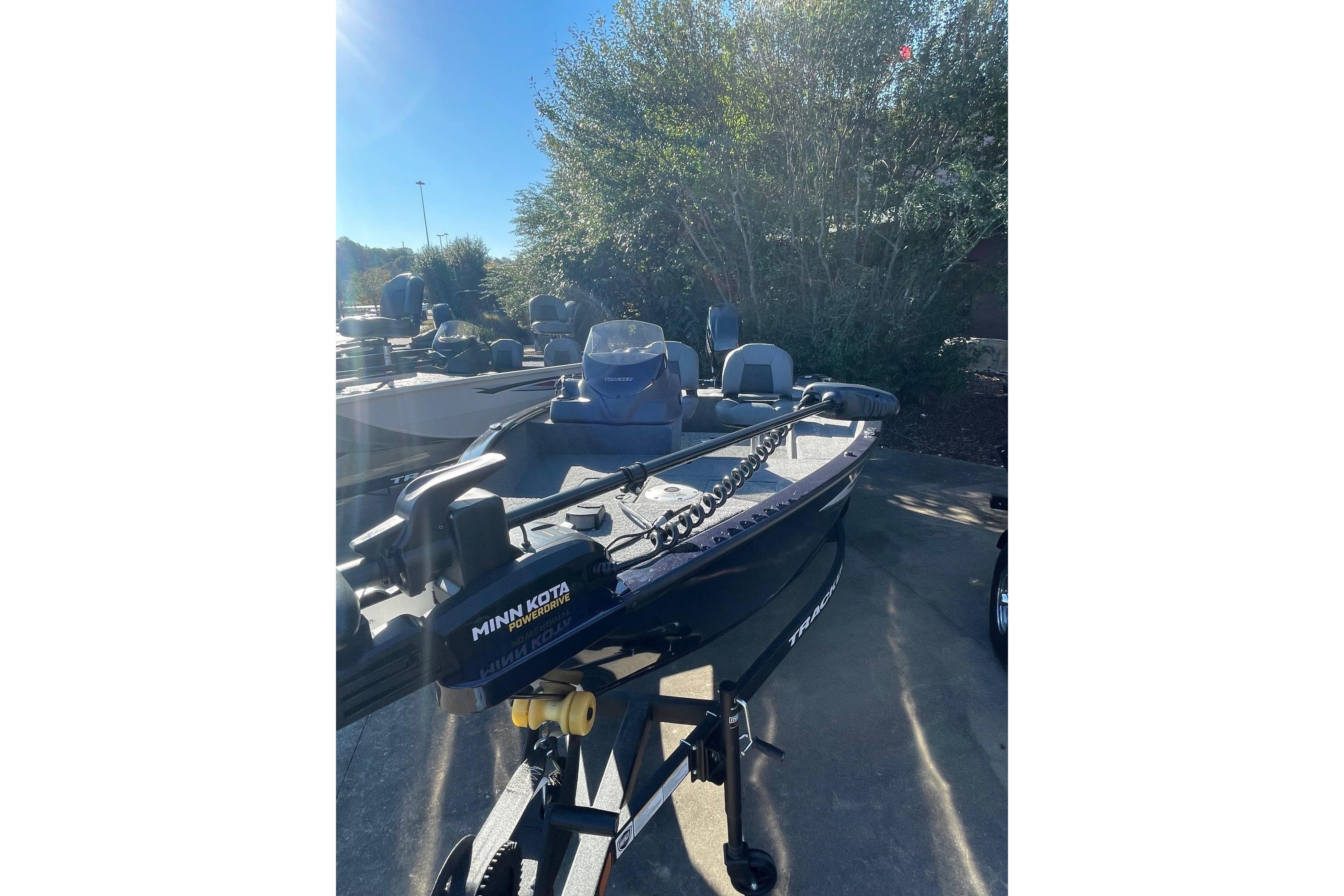 2026 Tracker Super Guide V-16 SC boat with Minn Kota PowerDrive motor in outdoor setting.