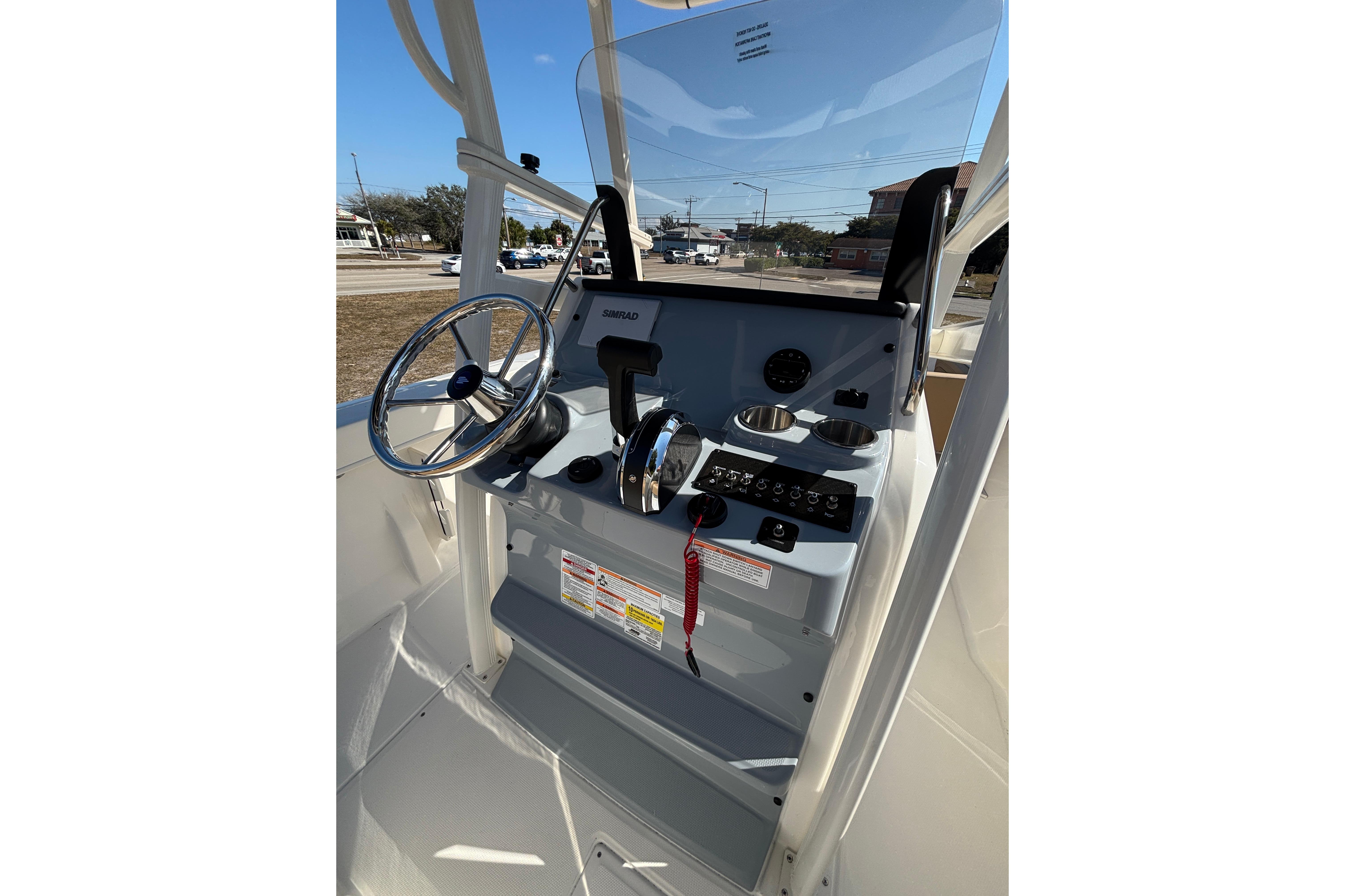 2026 Bayliner Trophy T22CC boat console with steering wheel and controls.