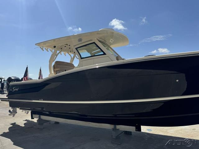 2022 Scout 330 LXF boat on display under clear blue sky.