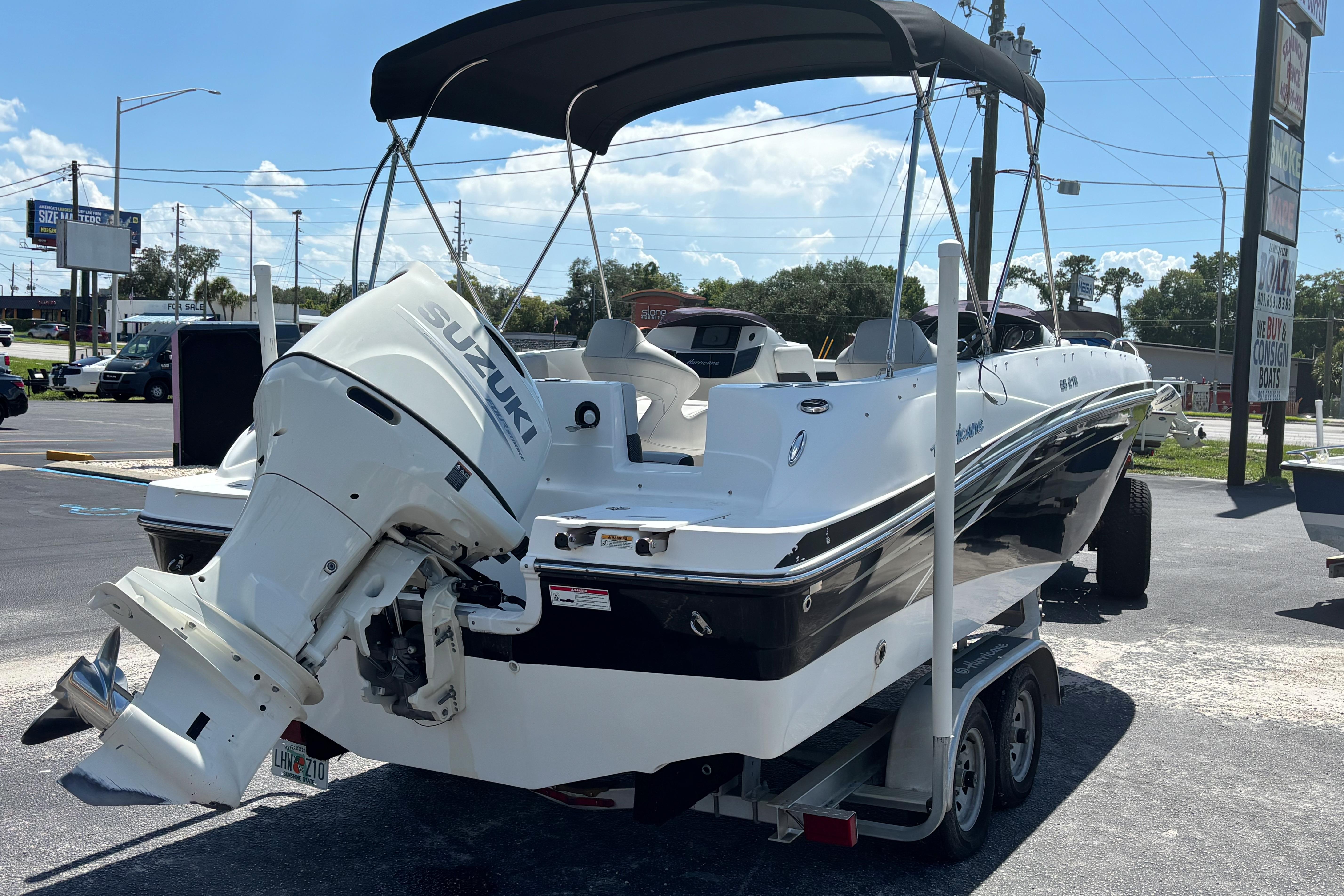 2019 Hurricane Sundeck Sport 218 OB boat with Suzuki outboard motor on trailer.