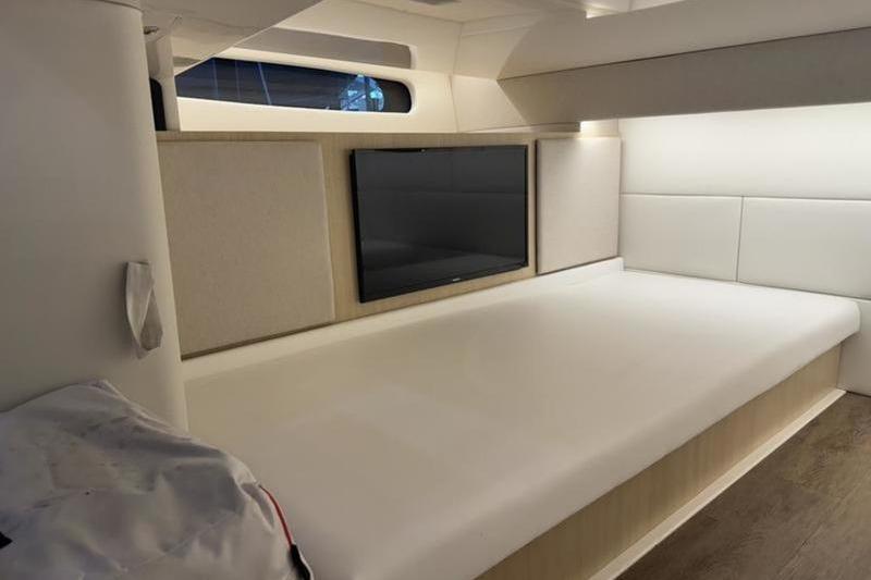Interior cabin of 2023 Regal 36 Grande Coupe with modern design and TV.