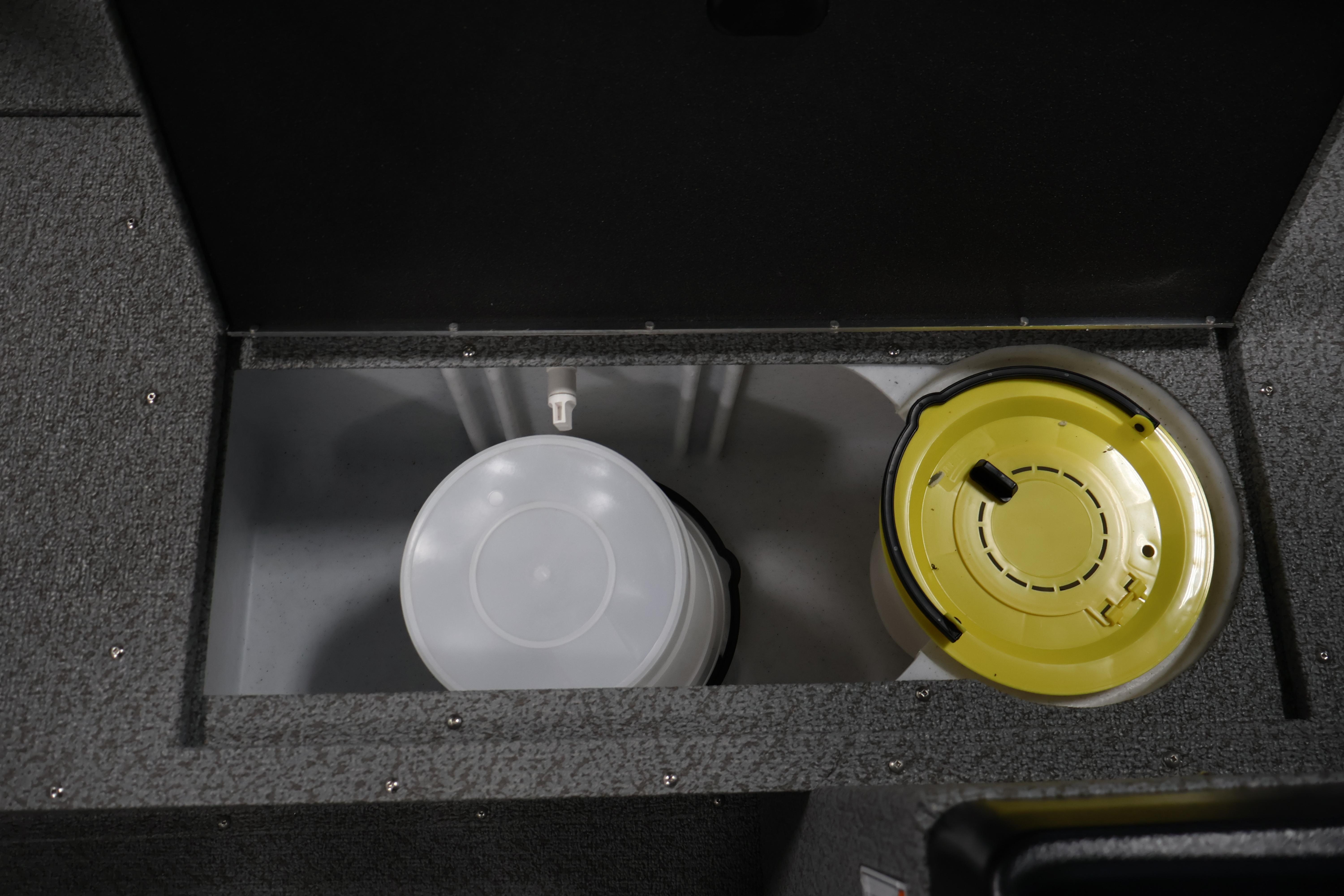 Storage compartment in 2026 Crestliner 1850 Kodiak SC boat, featuring a bucket and yellow lid.