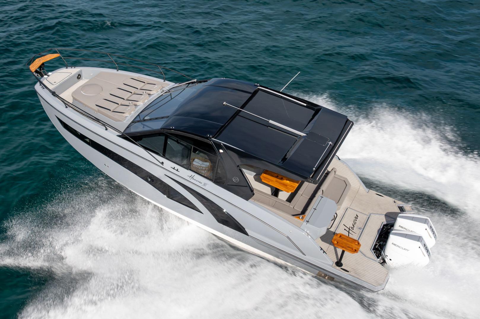 2026 Hanover 387 boat cruising on open water, showcasing sleek design and powerful engines.