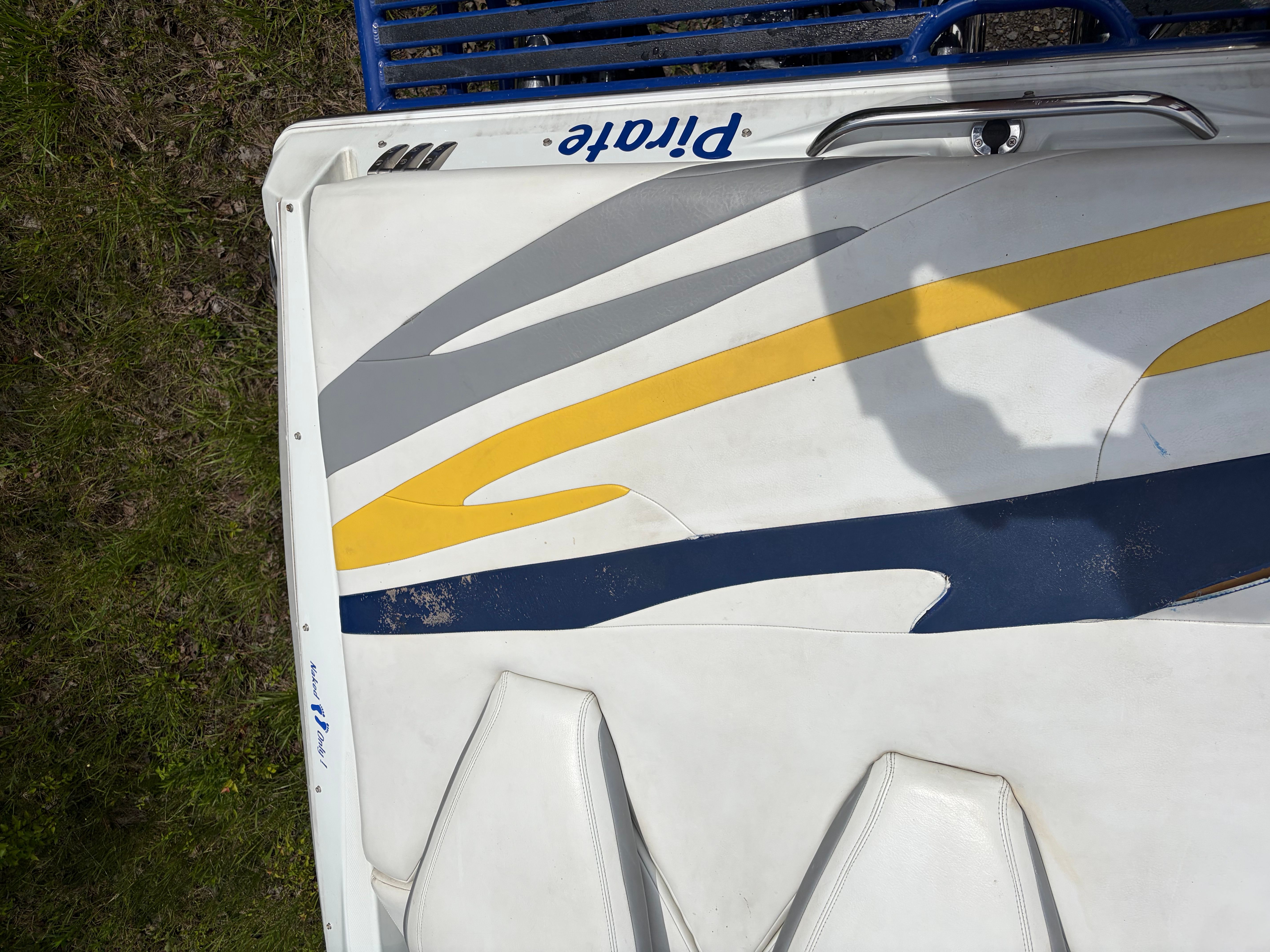Baja 30 Outlaw 2007 boat with yellow and gray stripes.