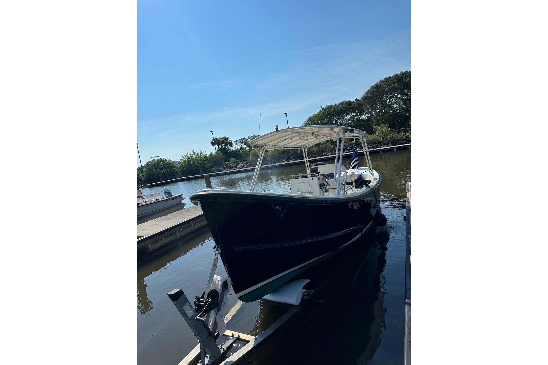 1997 Ocean Technical Services boat docked in a serene marina setting.