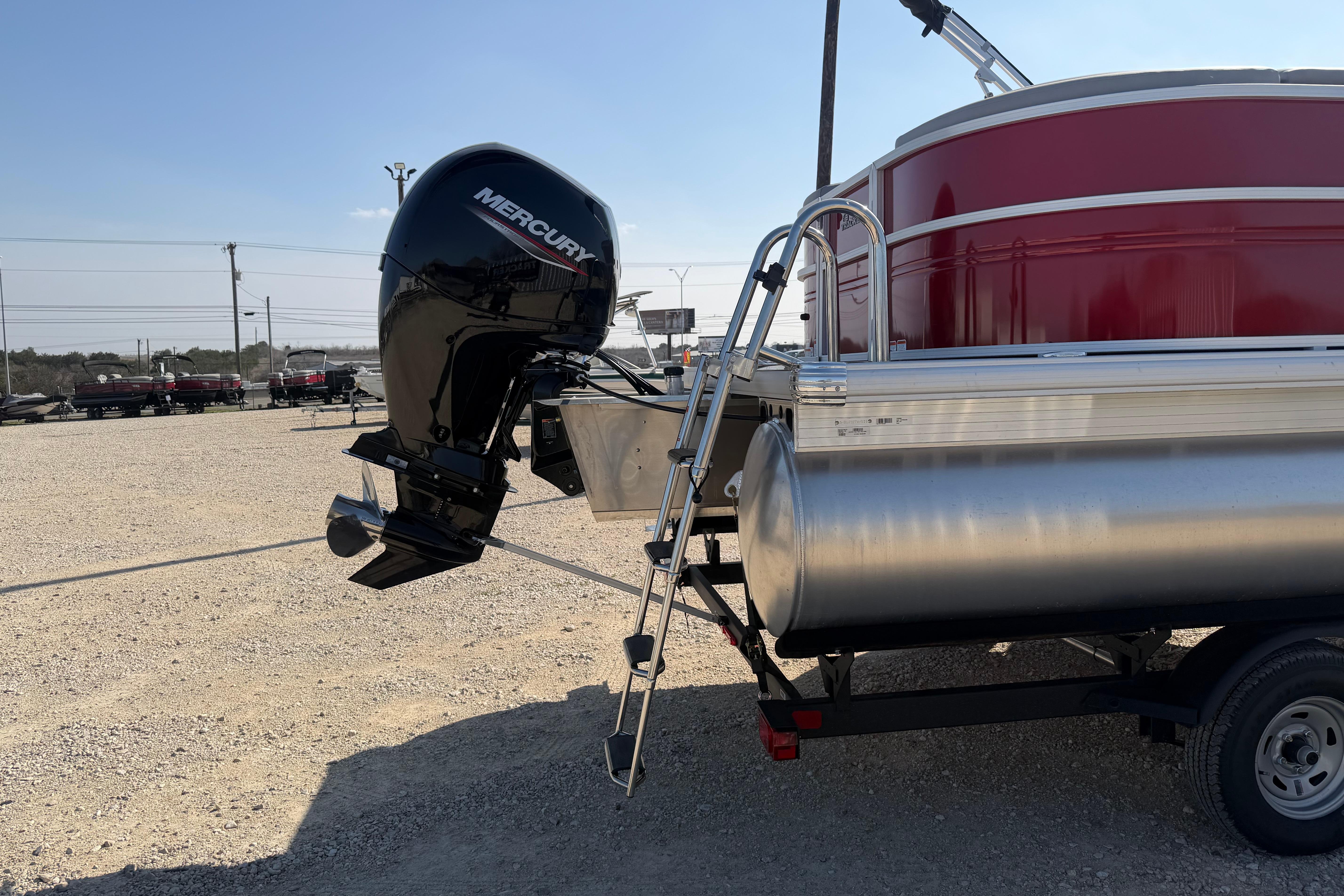 2026 Sun Tracker Party Barge 22 DLX with Mercury outboard motor on trailer.