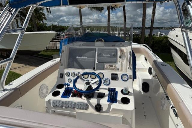 2005 Dakota 36 CC Forward Cuddy Cabin boat cockpit with steering wheel and control panel.