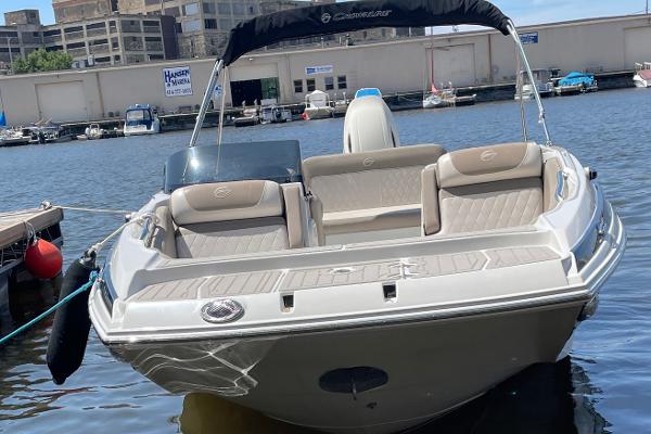 2020 Crownline E 205 XS boat docked at marina, featuring sleek design and comfortable seating.