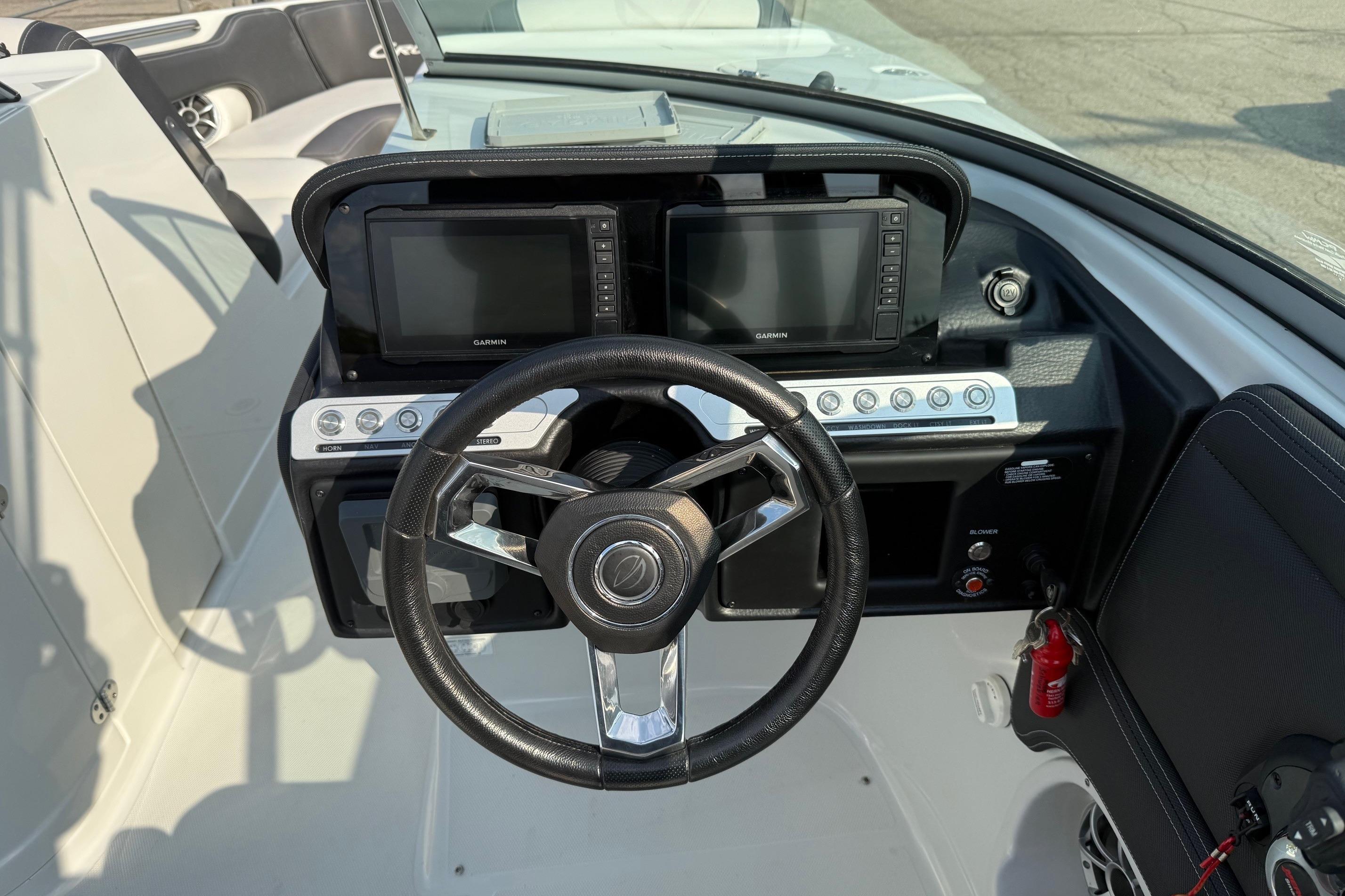 2023 Crownline 260 SS boat dashboard with steering wheel and dual Garmin displays.