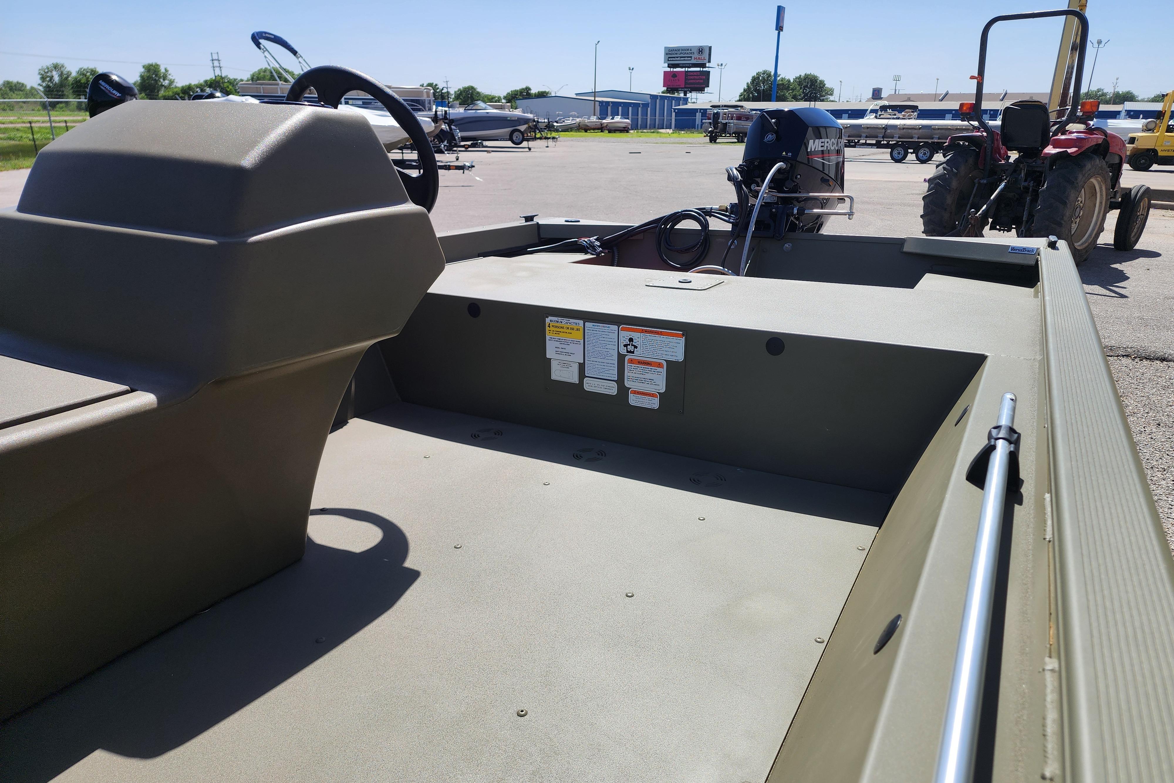 2026 Tracker Grizzly 1648 SC boat interior with steering console and Mercury engine.
