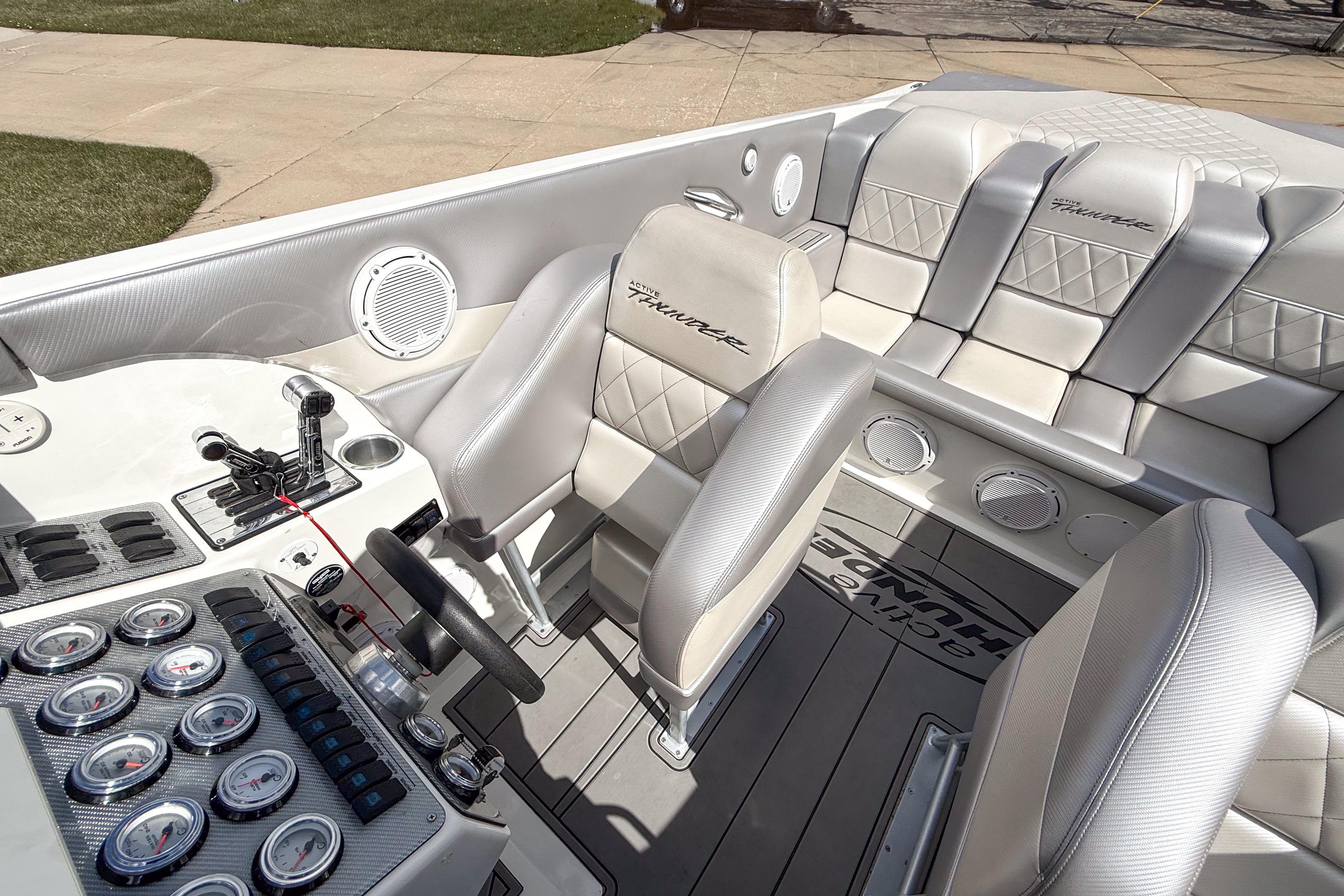 Interior of a 2002 Active Thunder 37 boat with luxurious seating and control panel.