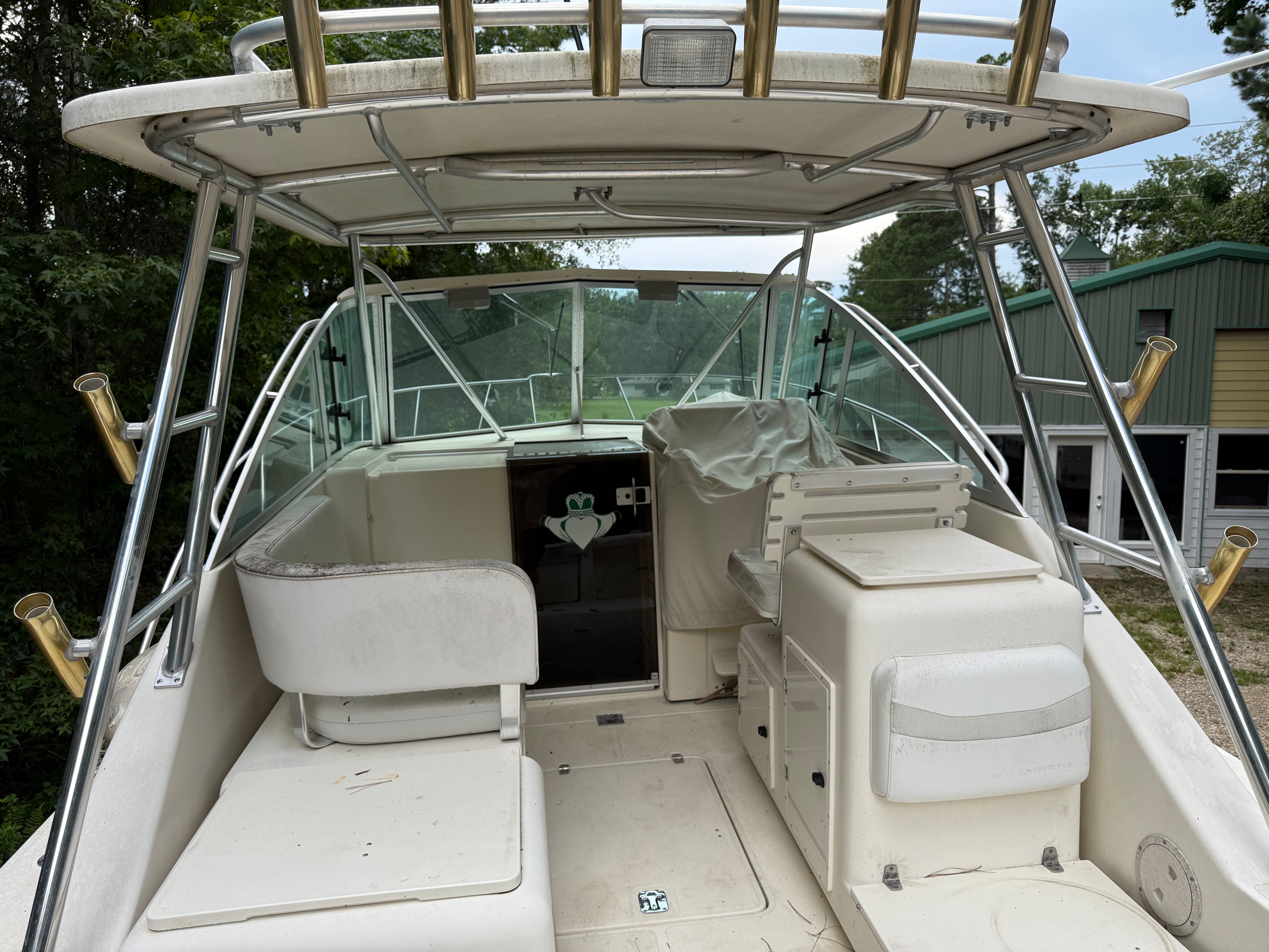 The image shows the cockpit of a 2002 Pursuit 3000 Express boat with seating and helm.