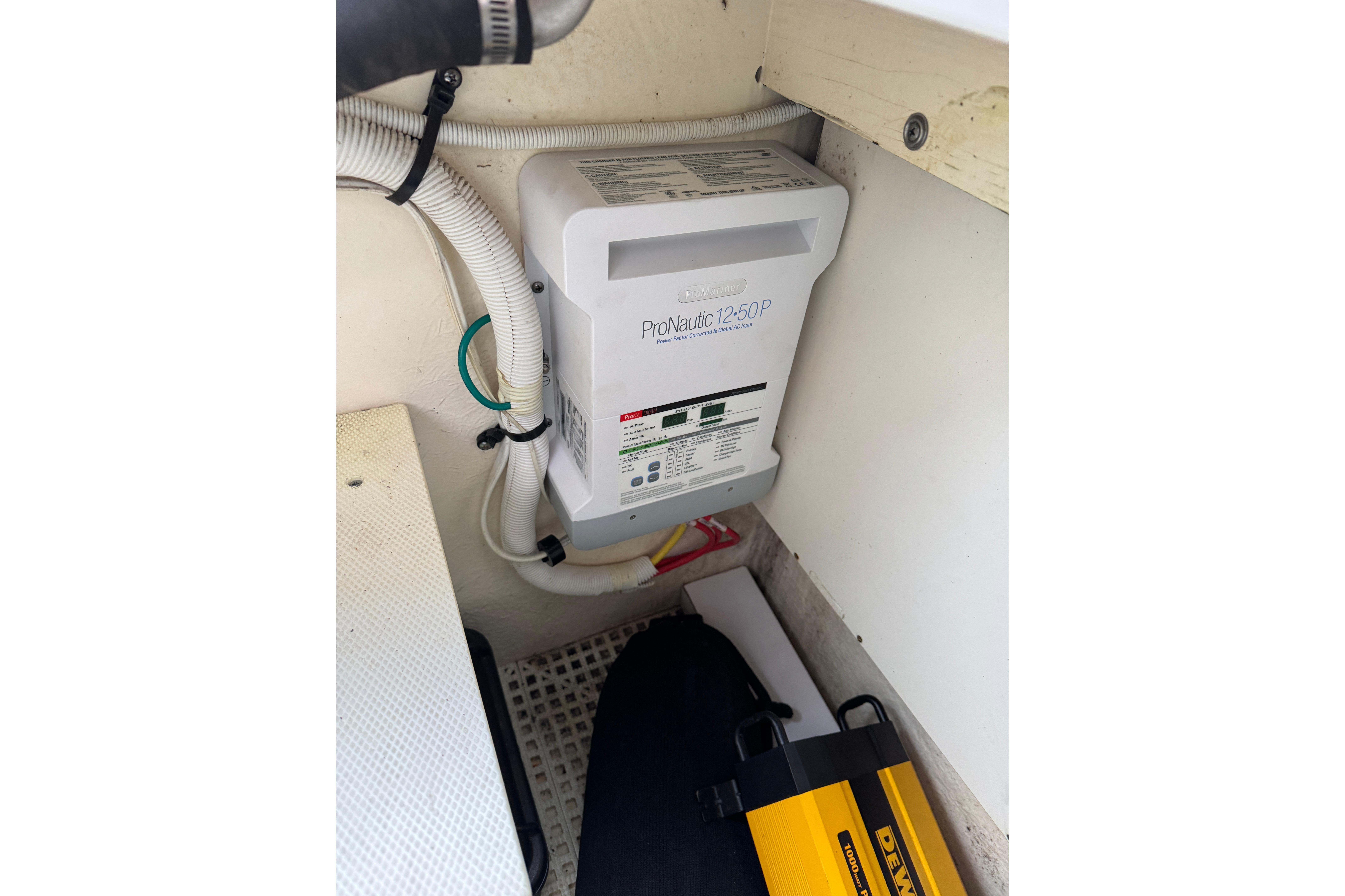 Battery charger in 2012 Chaparral 327 SSX boat interior, featuring ProNautic 12-50P model.