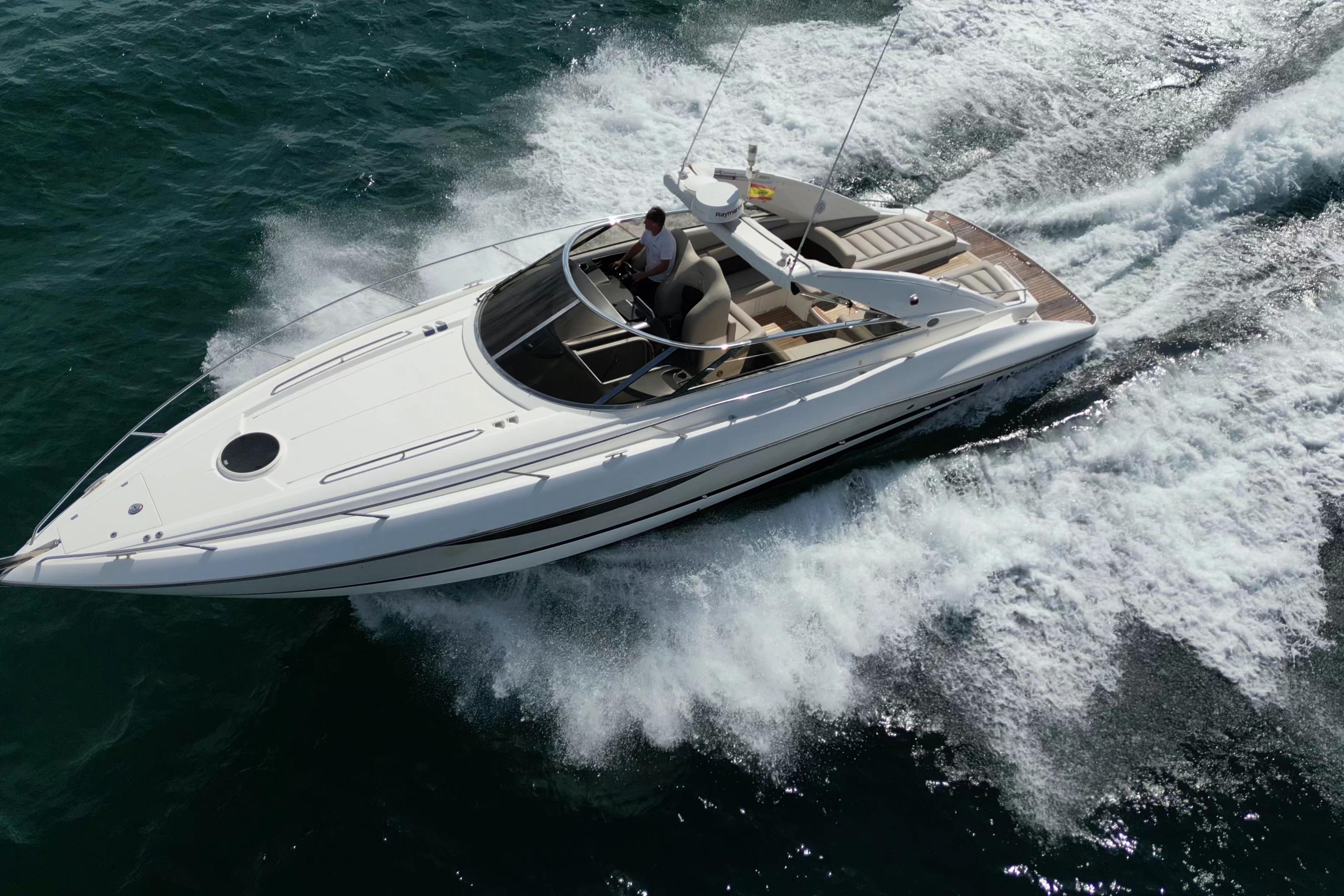 2007 Sunseeker Superhawk 43 yacht cruising on open water, aerial view.