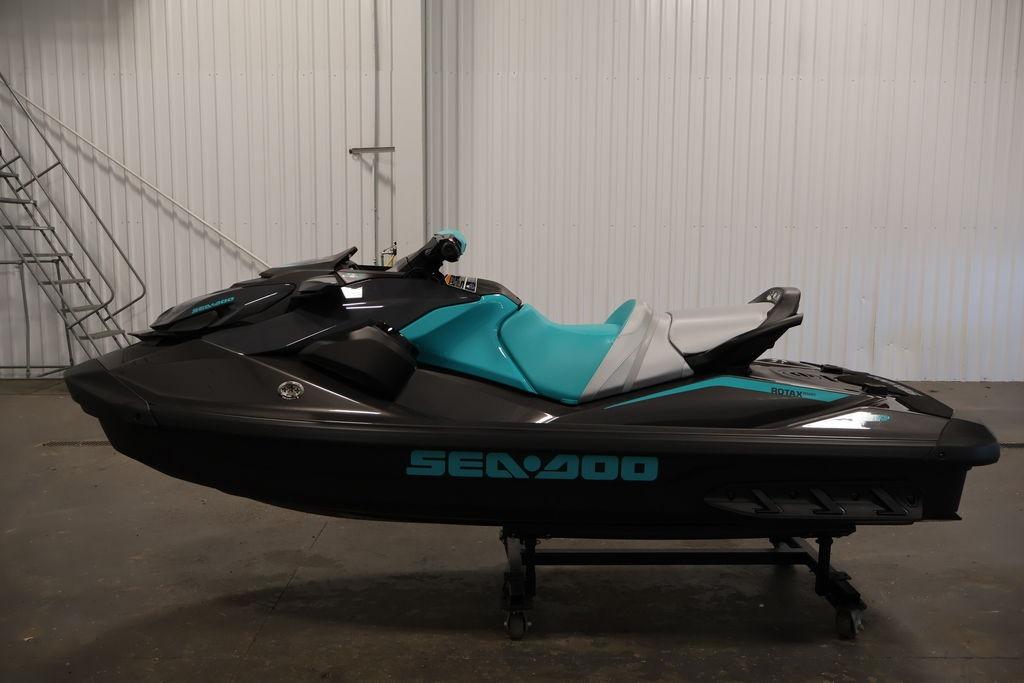 2026 Sea-Doo GTR 230 jet ski in a showroom, featuring sleek black and teal design.
