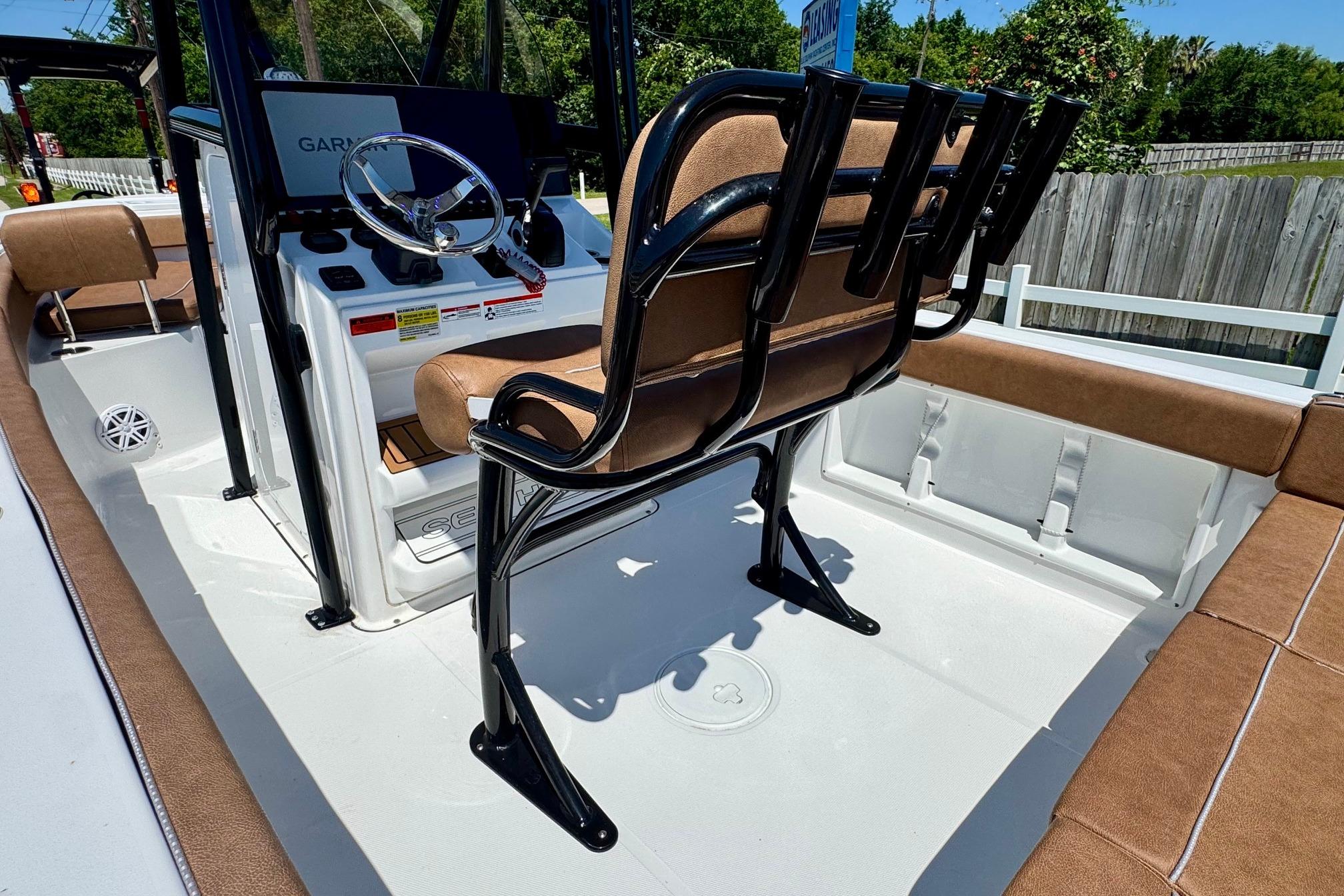 2025 Sea Hunt Ultra 219 boat interior with brown seating and steering console.