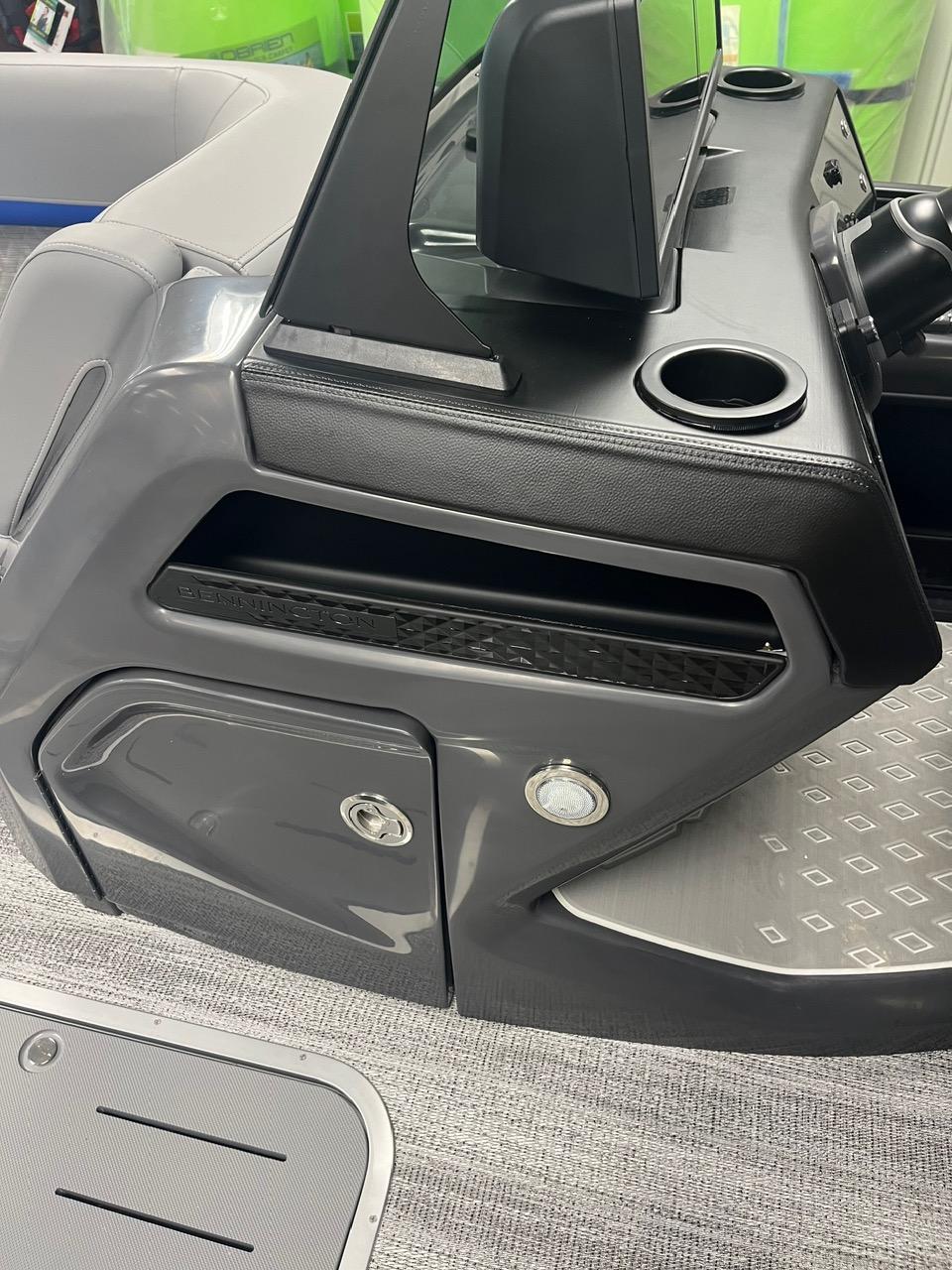 2025 Bennington 24 MSB boat console with cup holders and storage compartments.