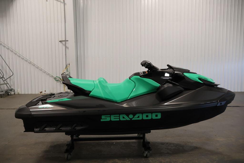 2026 Sea-Doo GTI SE 130 jet ski in a garage, featuring a sleek black and green design.
