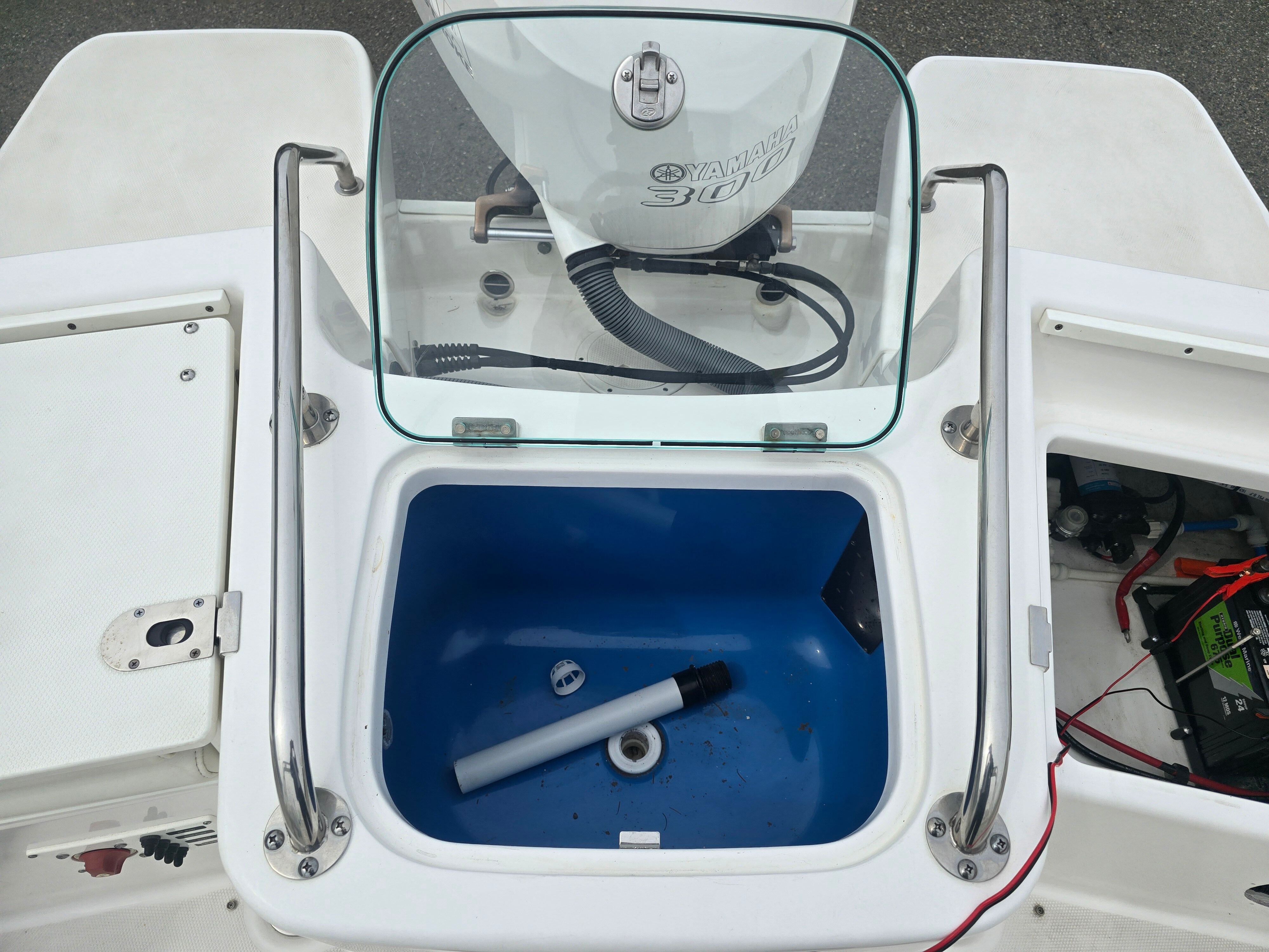 A 2017 Everglades 230 Dual Console with an open storage compartment and visible engine.