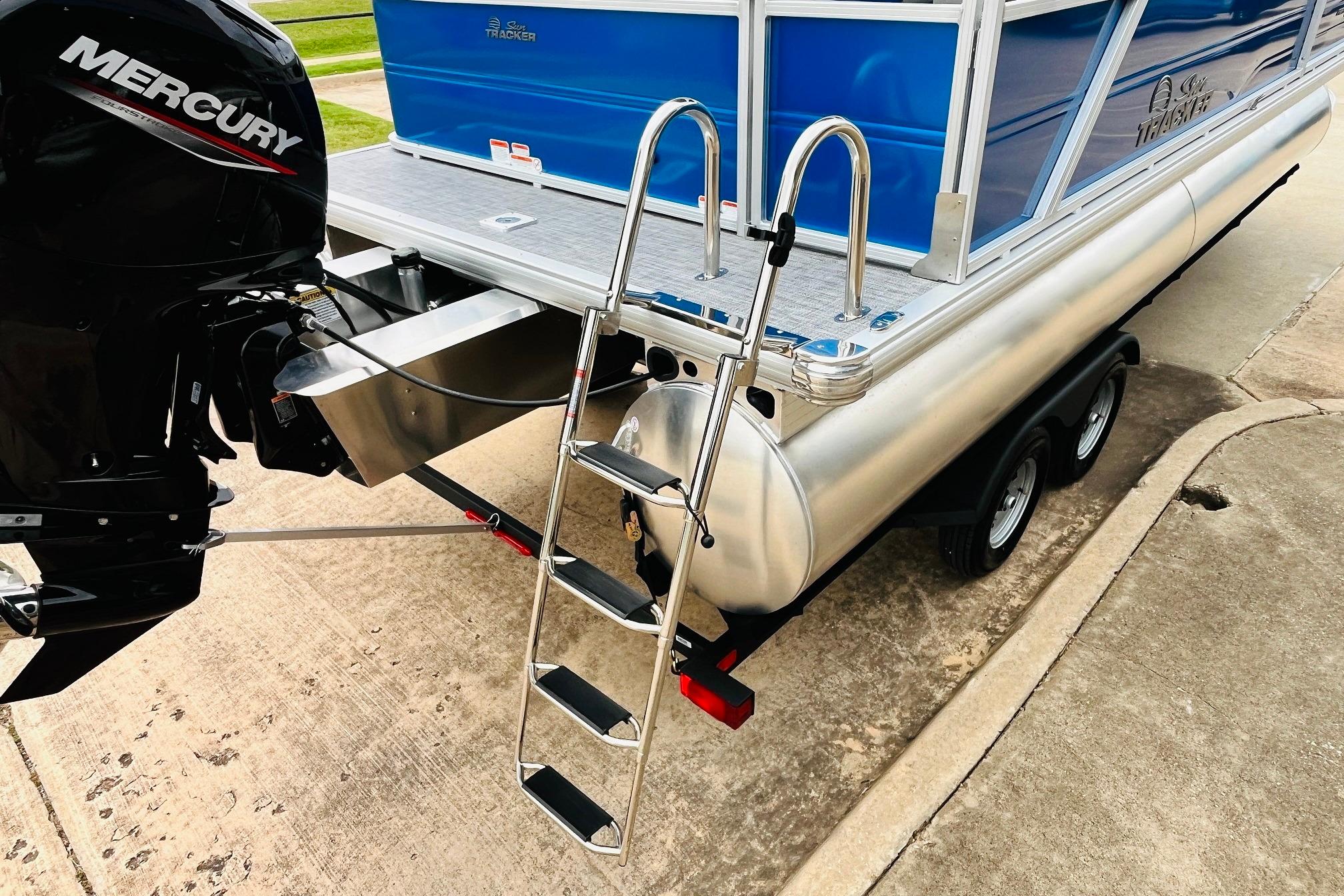 2026 Sun Tracker Party Barge 22 RF DLX with Mercury engine and ladder on trailer.