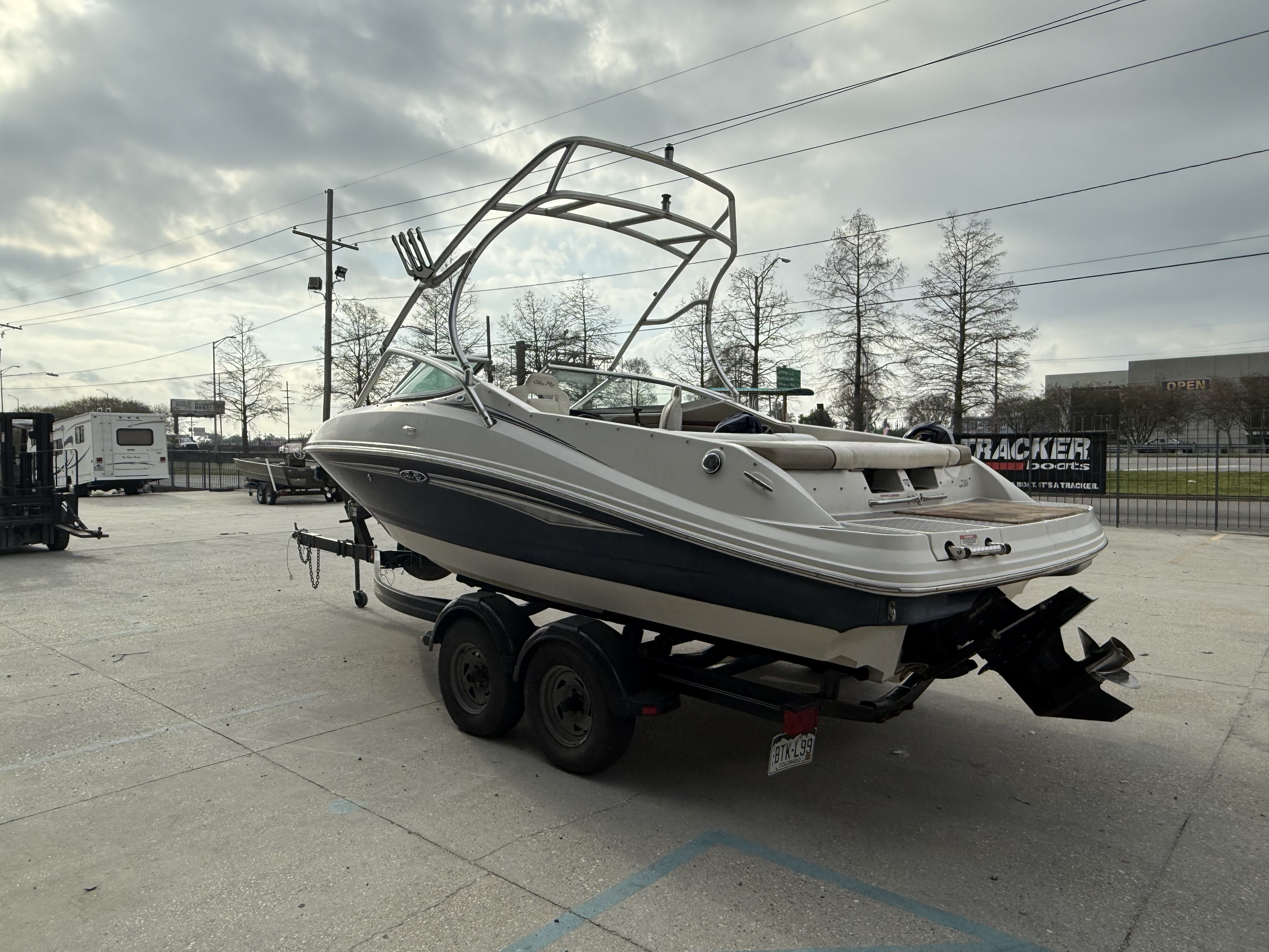 2007 Sea Ray 210 boat on trailer under cloudy sky.