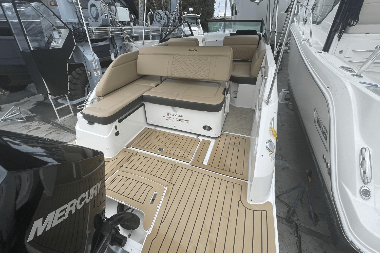 2019 Sea Ray SDX 250 Outboard boat with tan seating and Mercury engine.