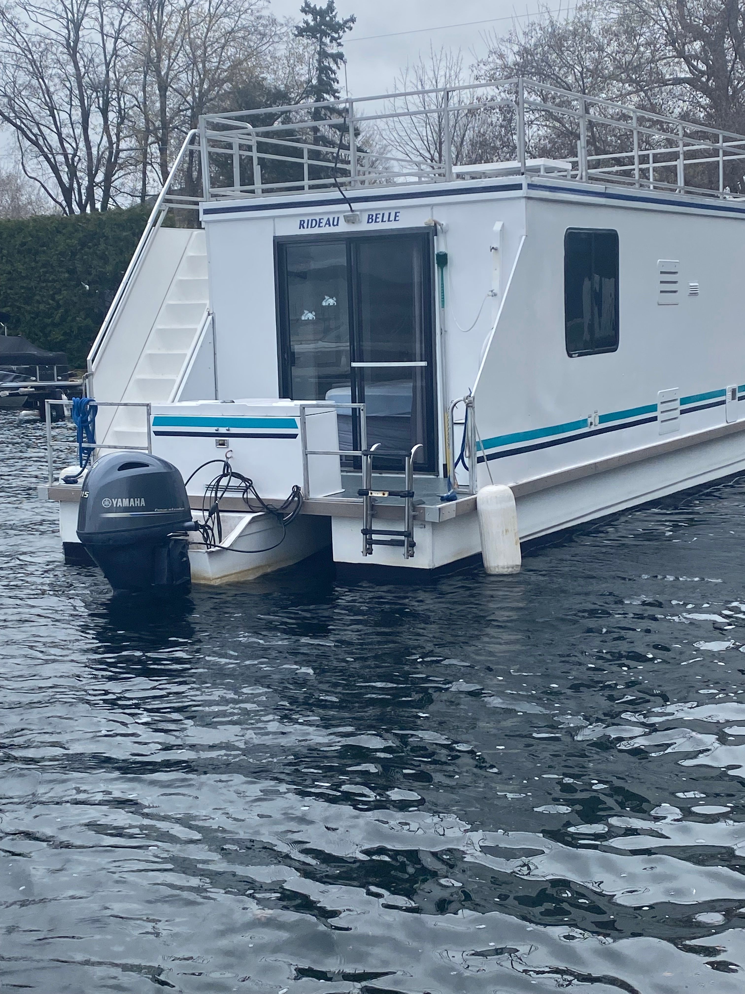 A 2004 42 ft catamaran with a Yamaha outboard motor, floating on calm water.