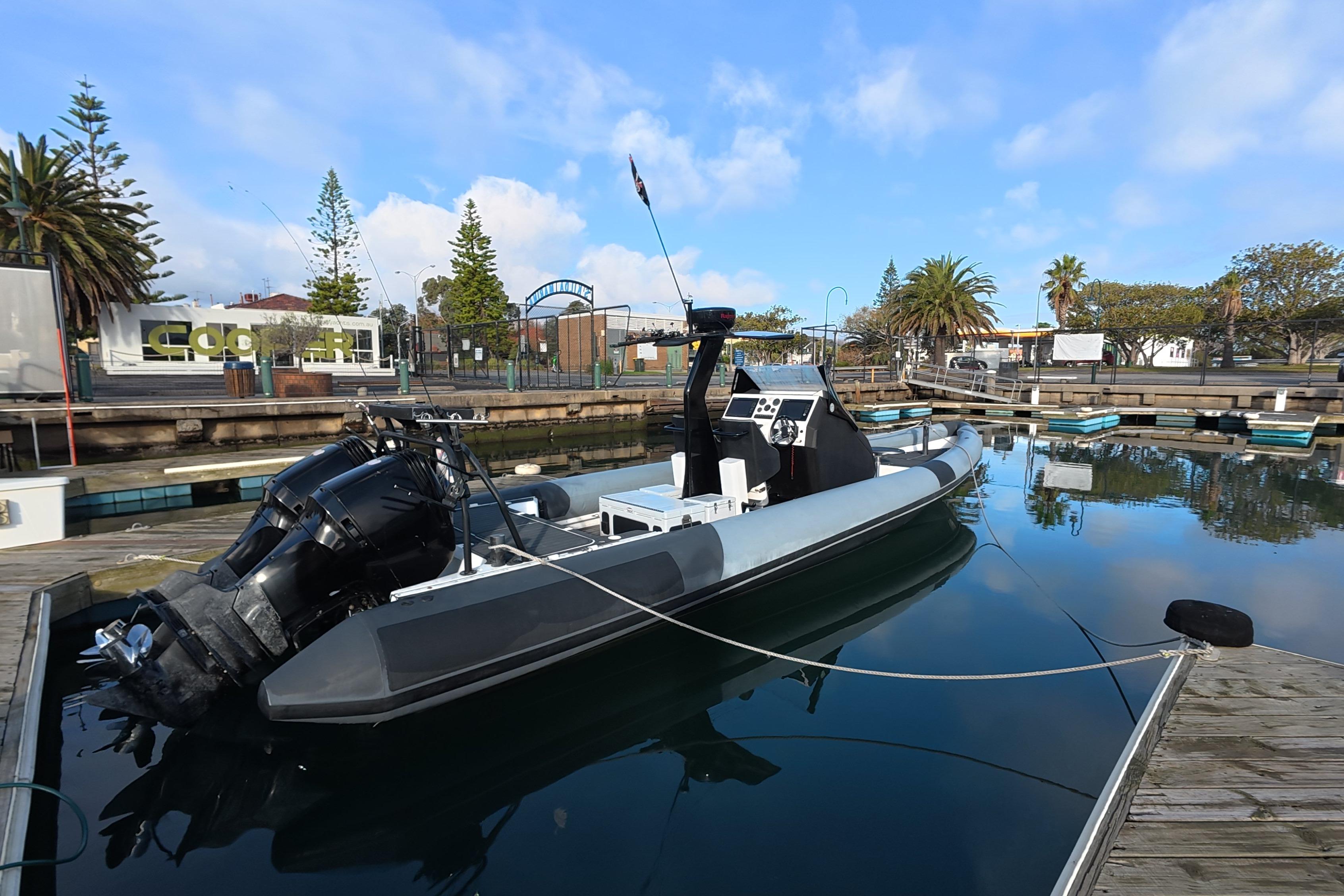 A sleek 2011 Radar 11.3m boat docked in a calm marina setting.