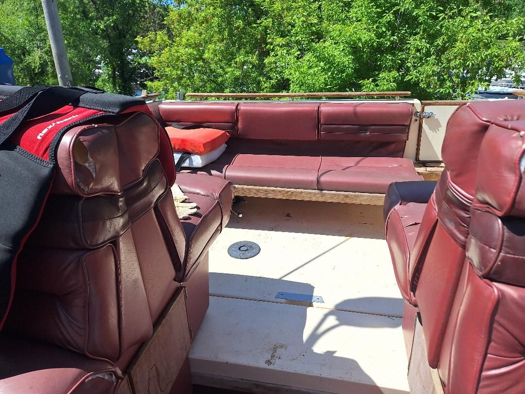 Interior of a 1986 Sea Ray Weekender 230 with red leather seats.