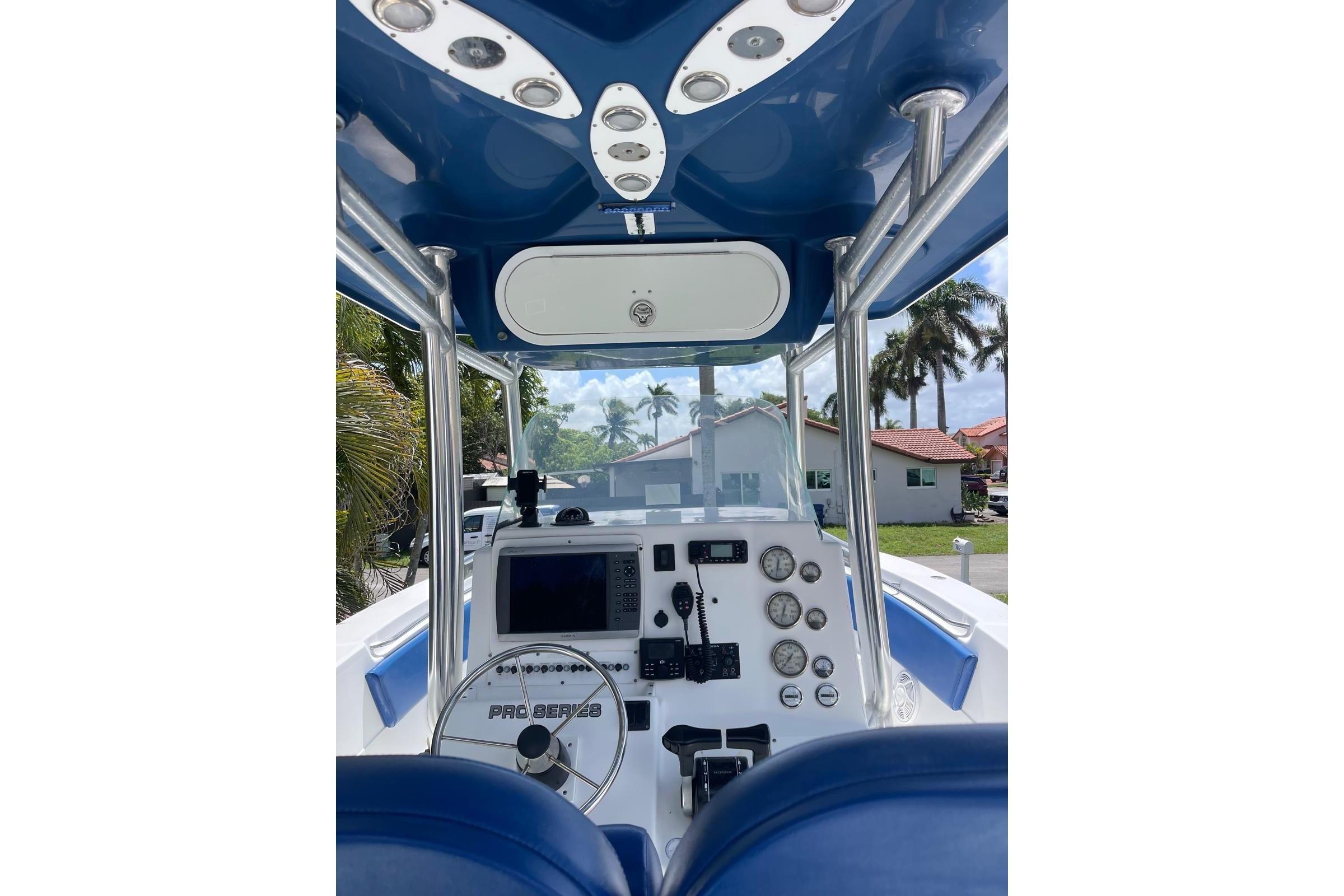 2009 Sea Fox 288 Commander boat dashboard with steering wheel and navigation instruments.