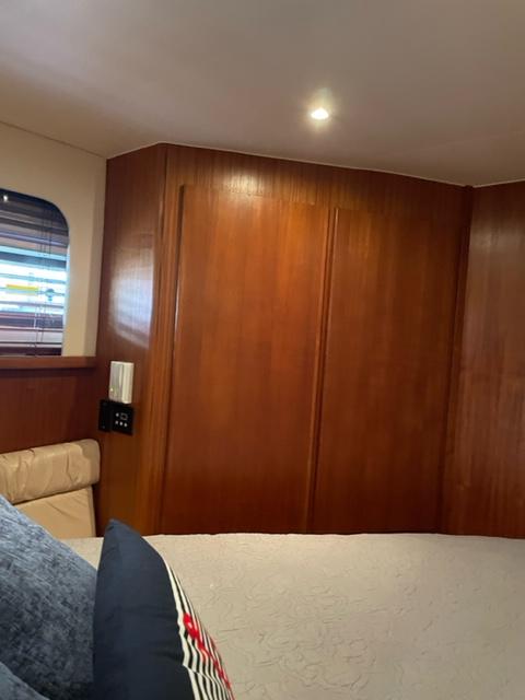 Interior cabin of a 1996 Carver 370 yacht with wooden paneling.