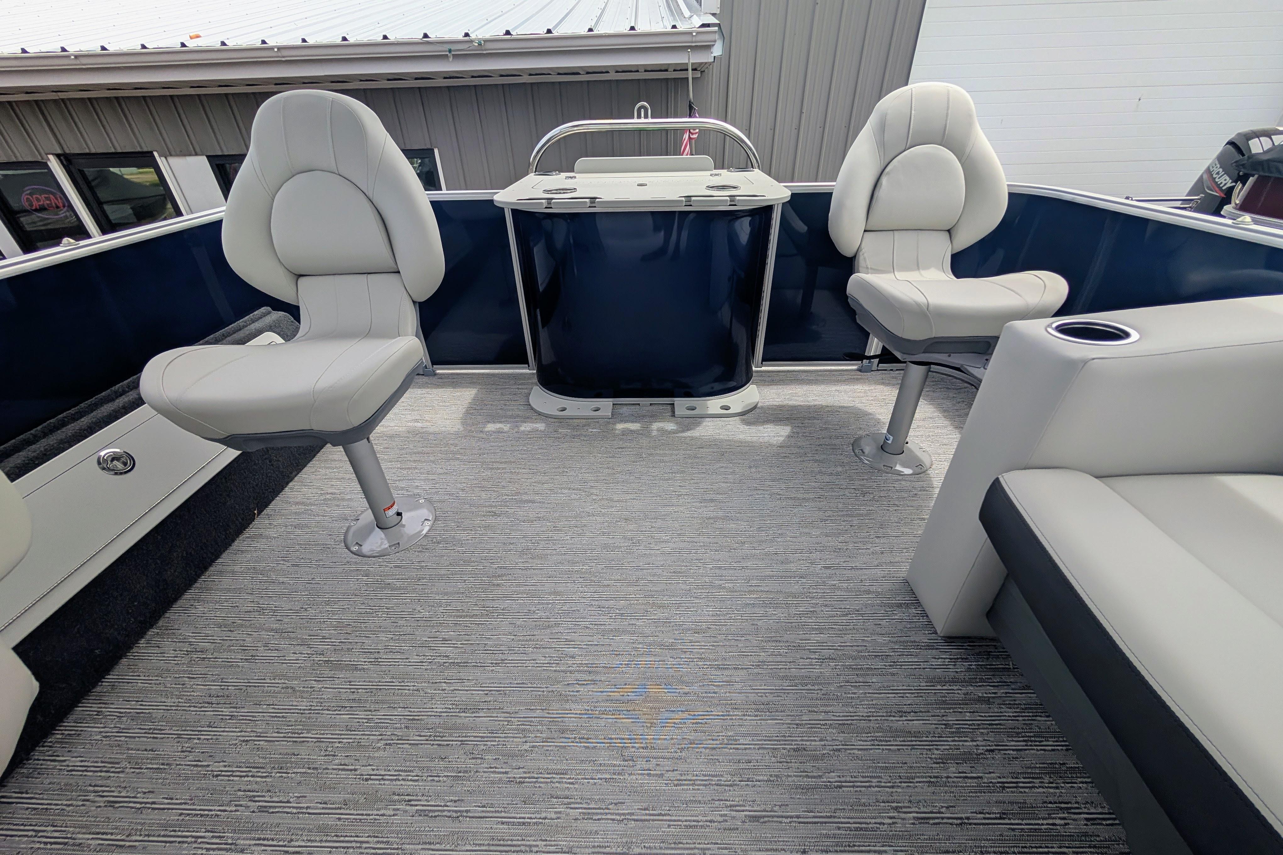 2026 Starcraft EX 20 F boat interior with swivel seats and carpeted flooring.