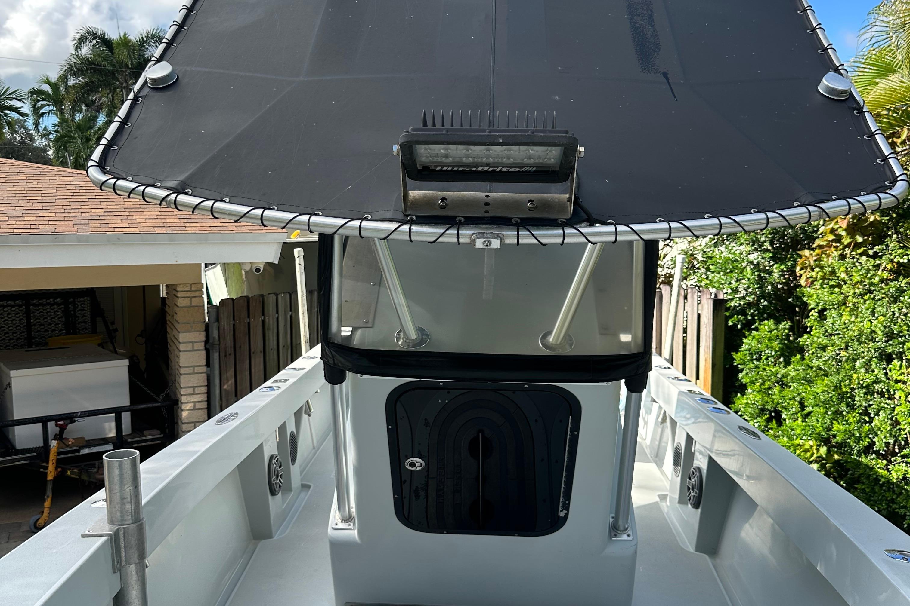 2004 SeaVee Center Console boat with T-top and forward deck view.