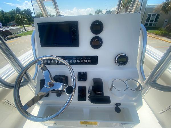 2024 Key West 239 FS boat console with steering wheel, gauges, and navigation system.