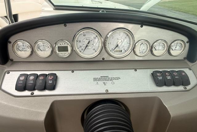 Dashboard of a 2007 Regal 2200 Bowrider boat with gauges and controls.