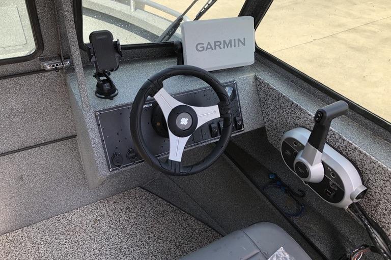 2023 Alumaweld Talon 18 boat cockpit with Garmin navigation system and steering wheel.