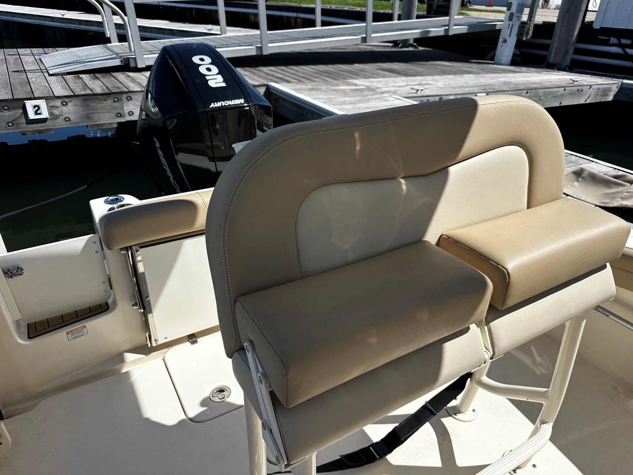 Scout 210XSF 2022 boat at dock with outboard motor.
