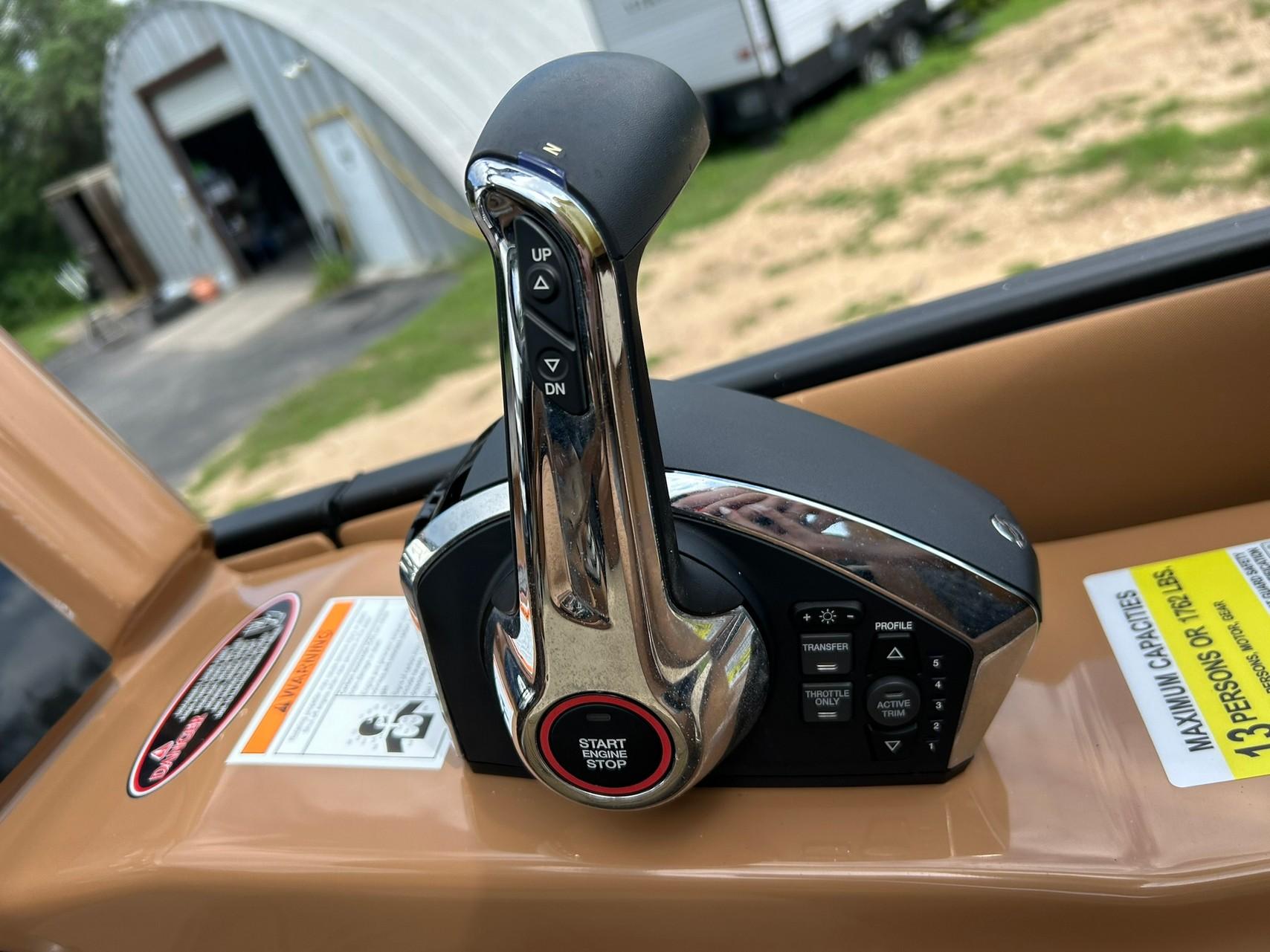 Throttle control of 2023 Harris Grand Mariner 230 boat, featuring start/stop button and trim controls.