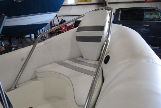 2000 Zodiac Yachtline 340DL inflatable boat interior with striped seating in a storage facility.
