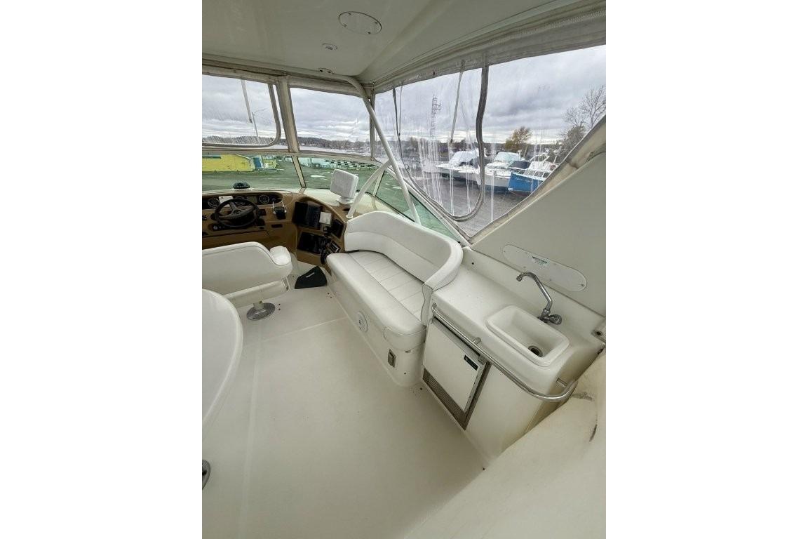 2004 Carver 450 Voyager Pilothouse interior with helm, seating, and sink.