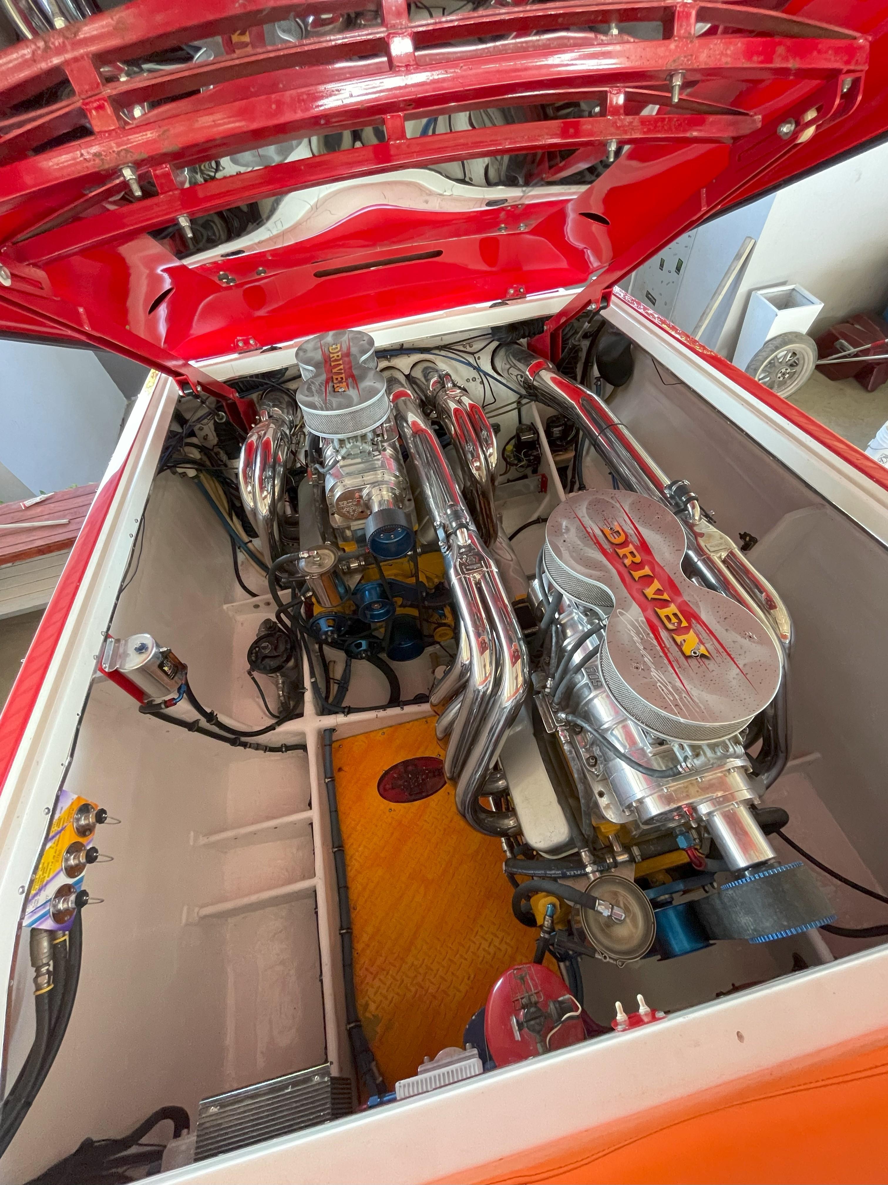 Engine compartment of a 2002 Cigarette ROUGH RIDER boat, showcasing dual high-performance engines.