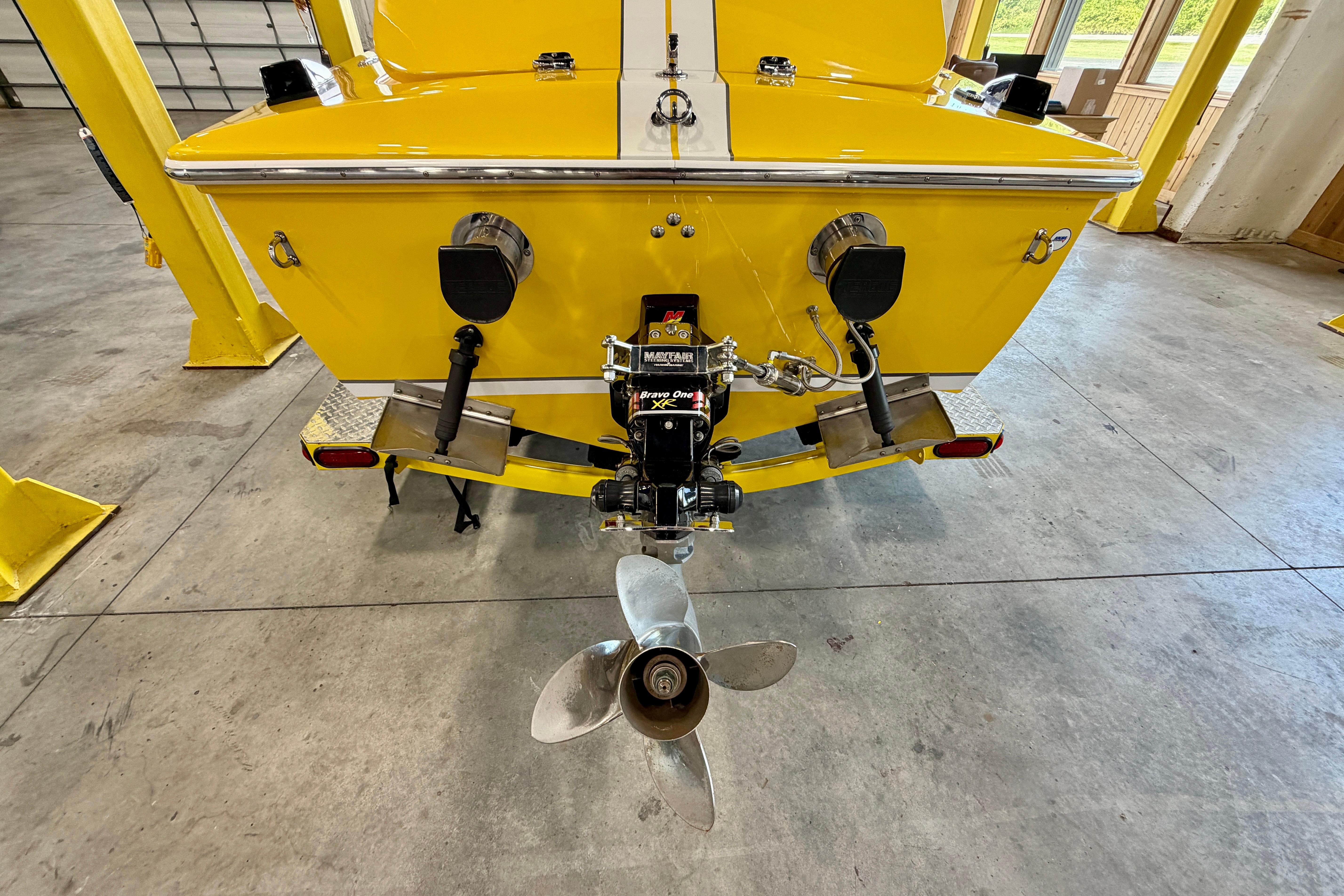 Rear view of a 2004 Donzi 22 Classic boat with yellow hull and propeller.