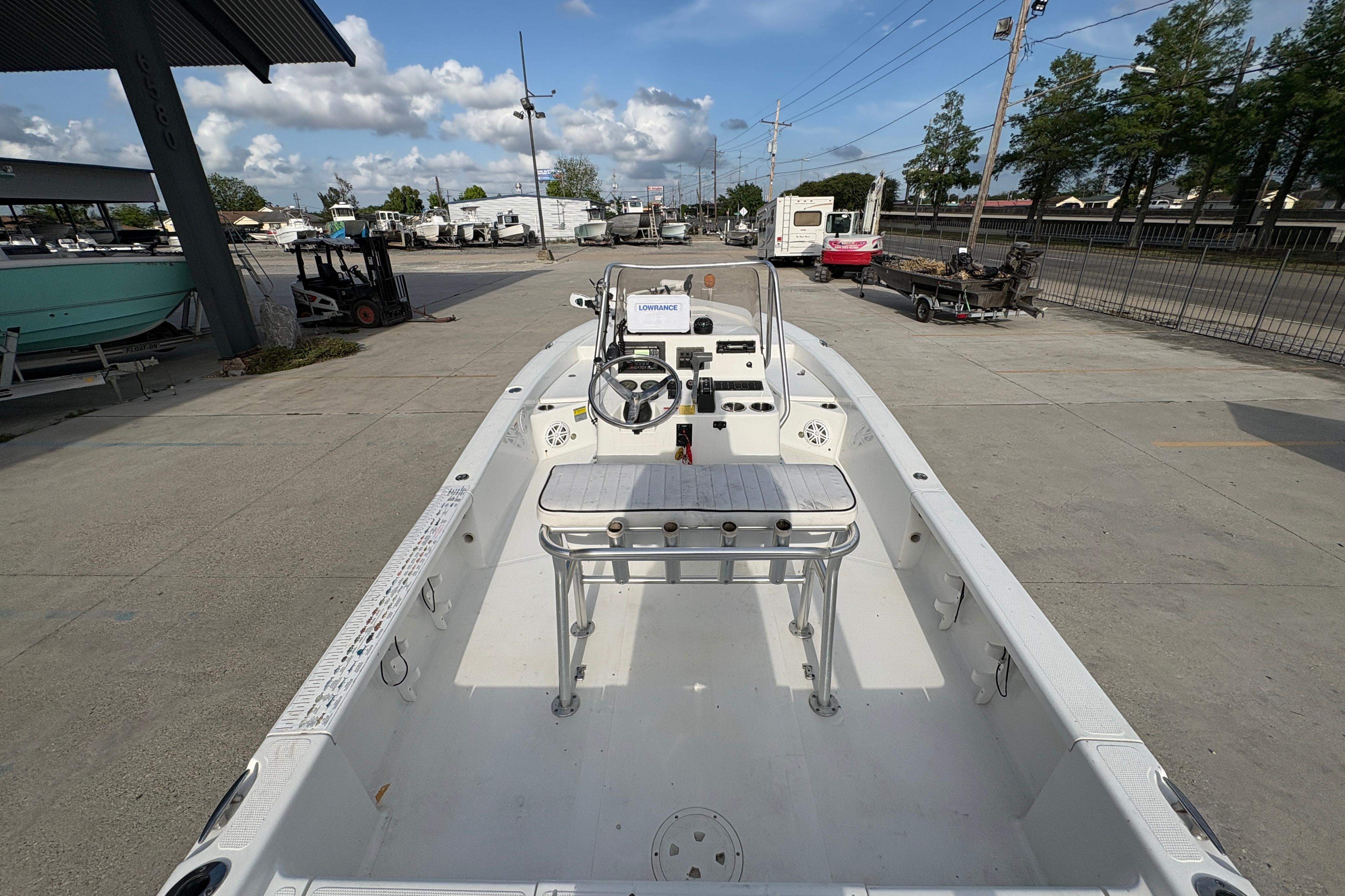 Open deck of a 2012 BlackJack 224 boat, parked outdoors under a clear sky.