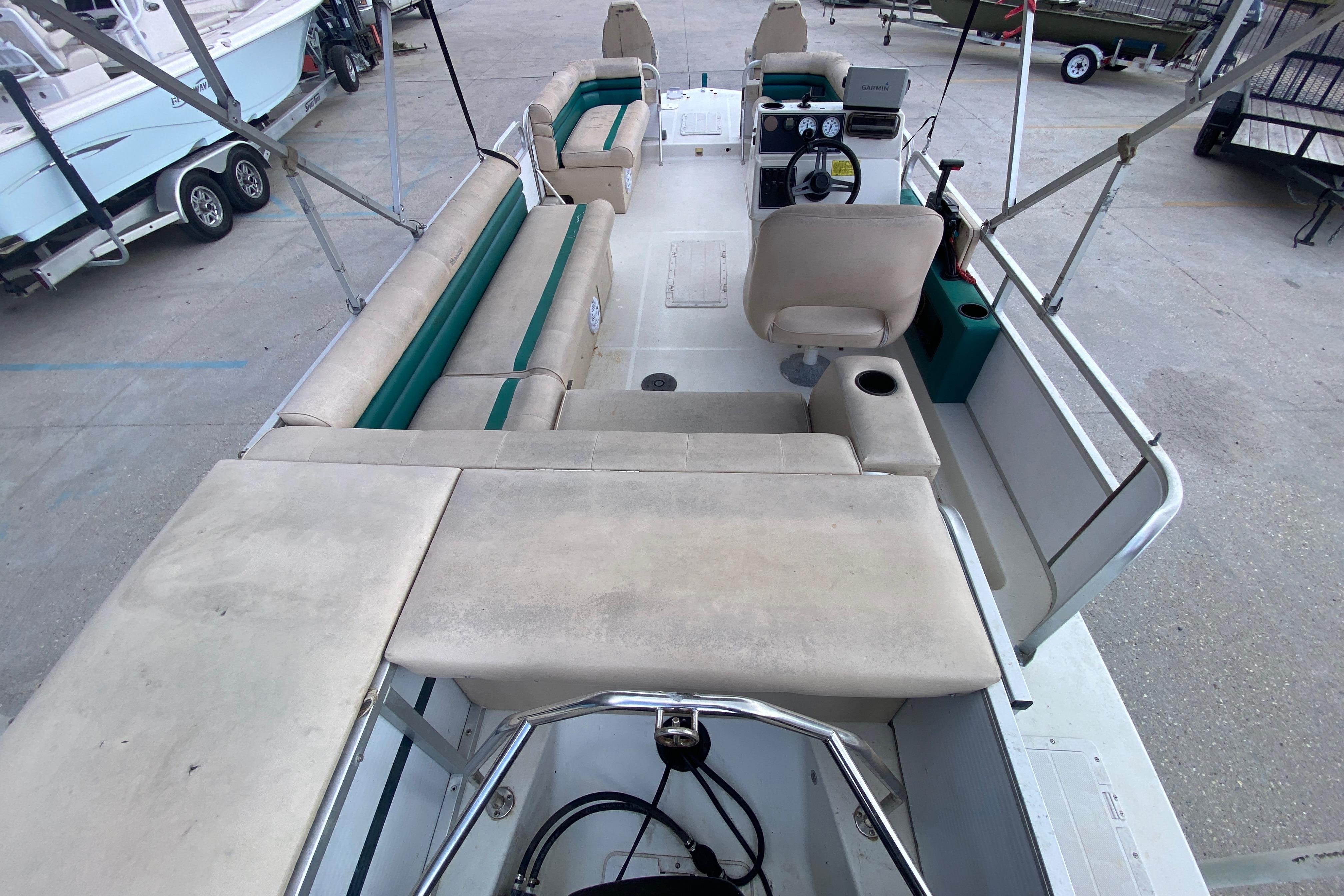 1994 Hurricane FunDeck 226 boat interior with beige seating and steering console.