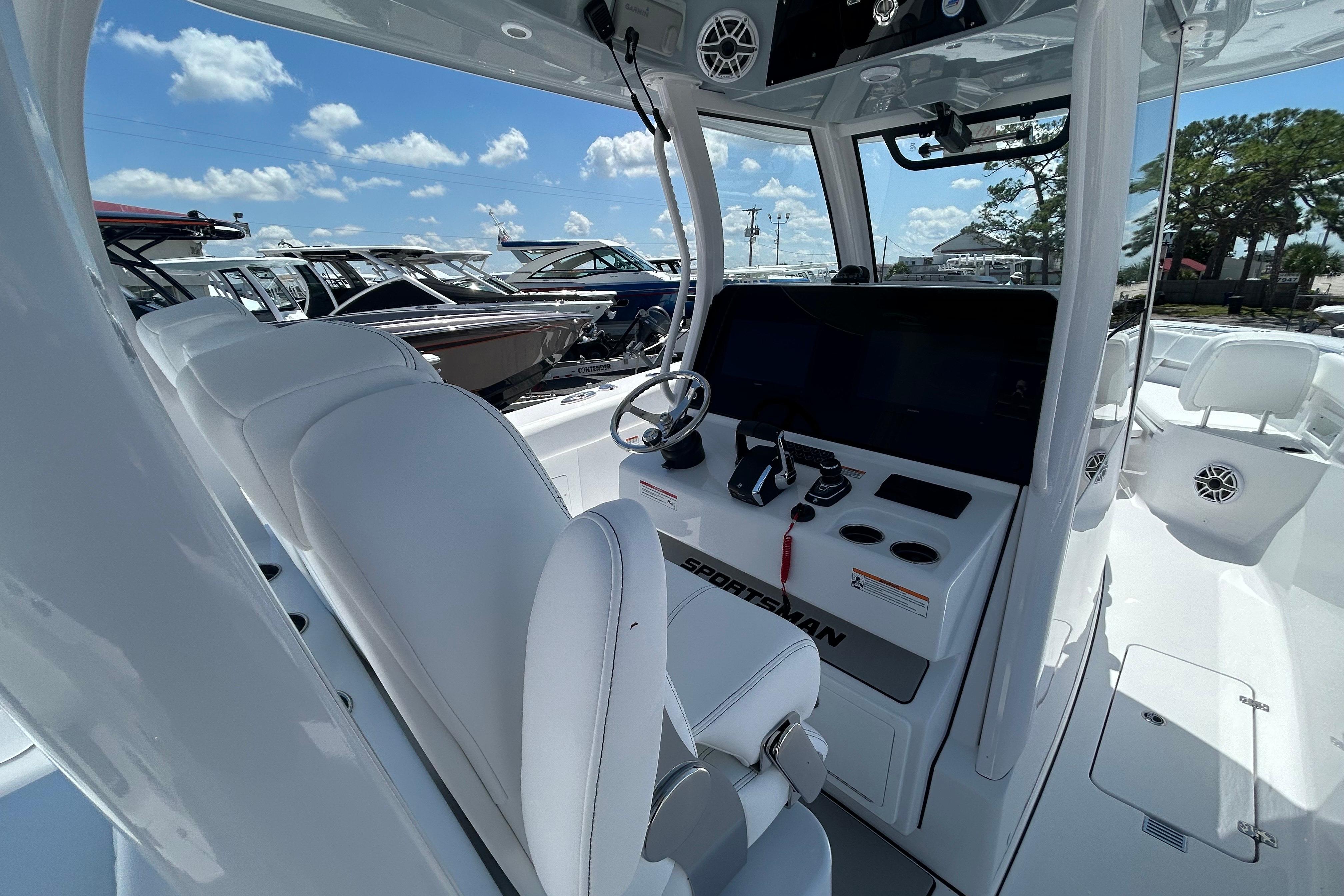 2026 Sportsman Heritage 321 Center Console boat interior with steering wheel and seating.
