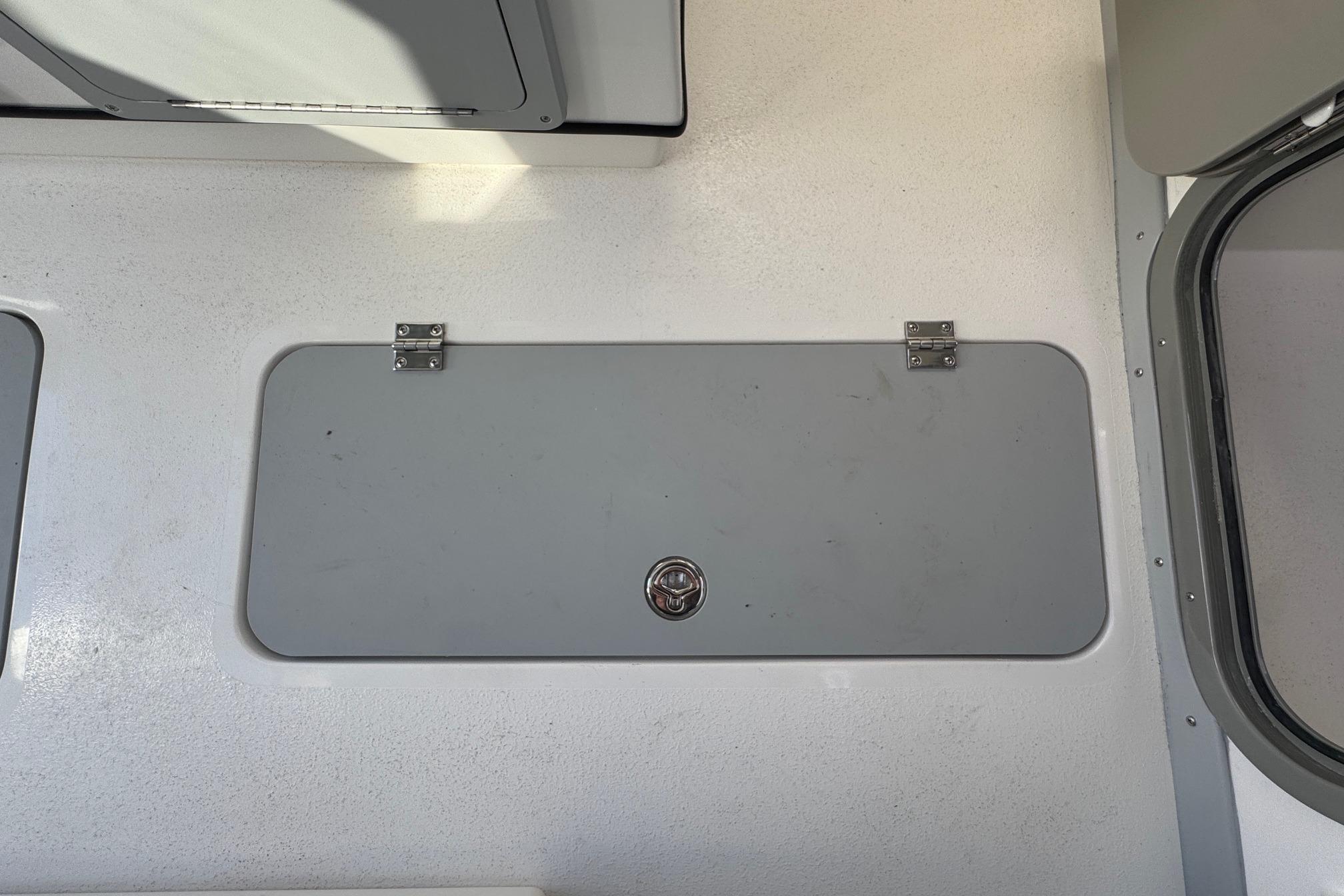 Hatch on 2026 Defiance Admiral 250 EX boat deck, featuring secure latch and hinges.