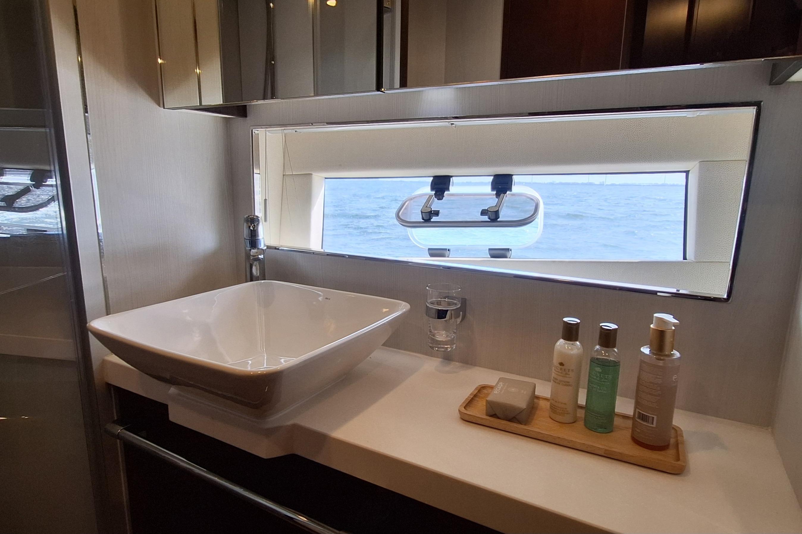Luxurious bathroom on 2022 Fairline Targa 53 yacht with ocean view window.